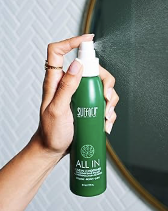 Applying leave-in conditioner for sun protection at Cedar Rose Salon in Byron Center Michigan