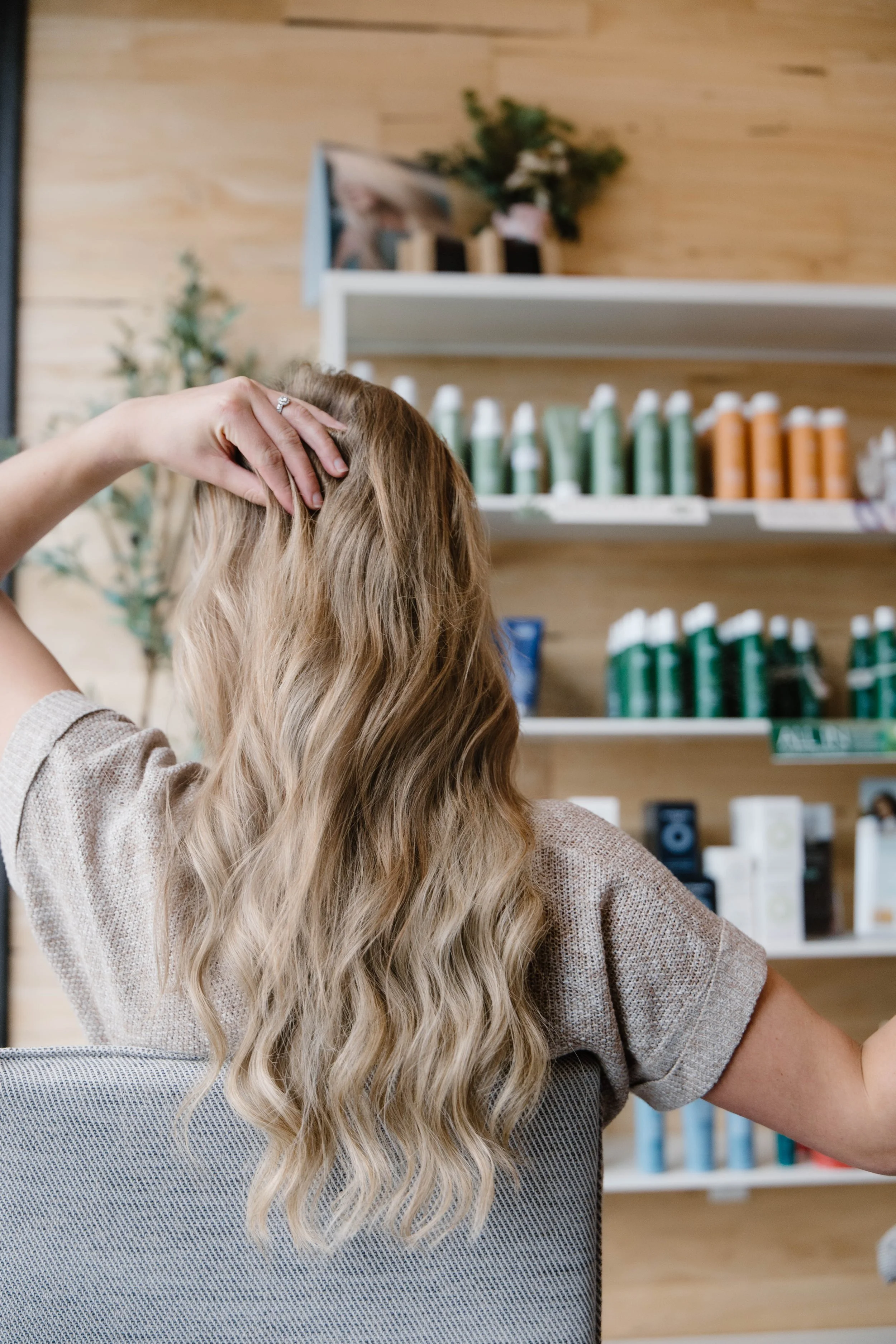 Stylist holding Surface Awaken Shampoo and Conditioner at Cedar Rose Salon & Suites in Byron Center, Michigan