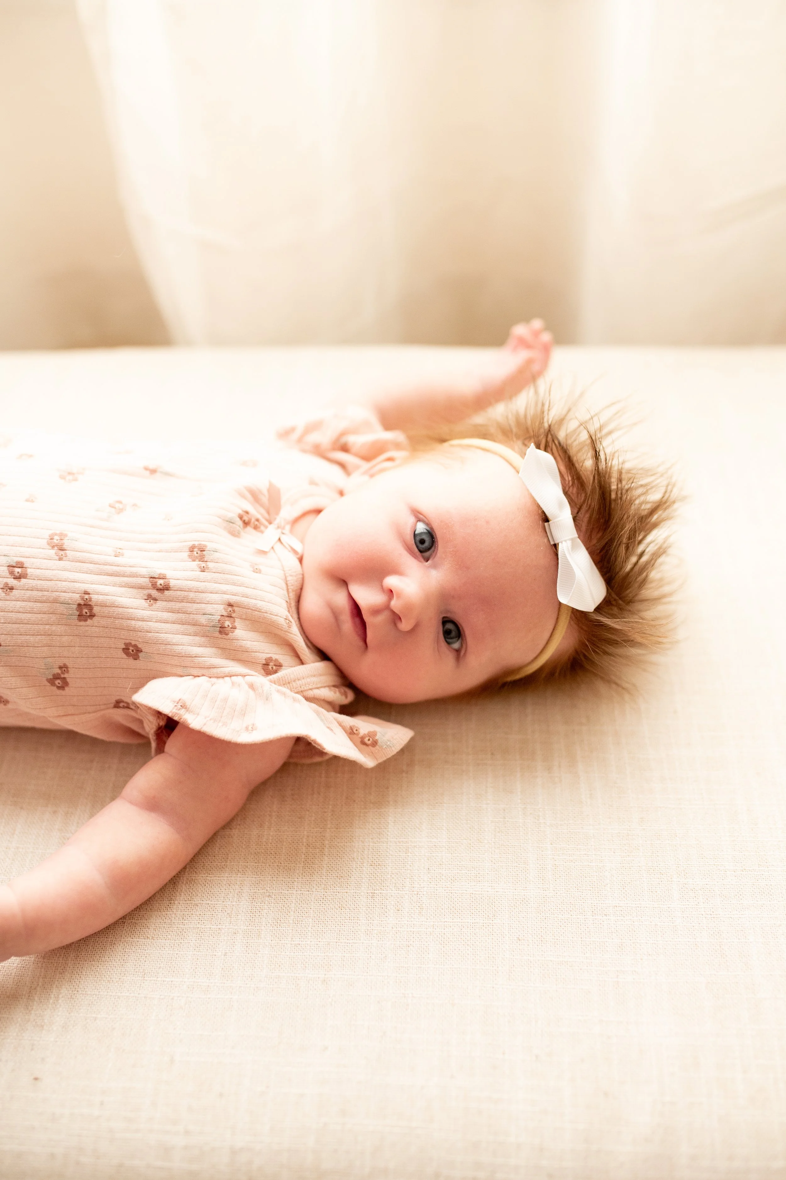 2 Month old baby smiles for the camera in natural light studio in downtown Bozeman, MT. Wanderbirth Photo, Mikaela DiBerardinis