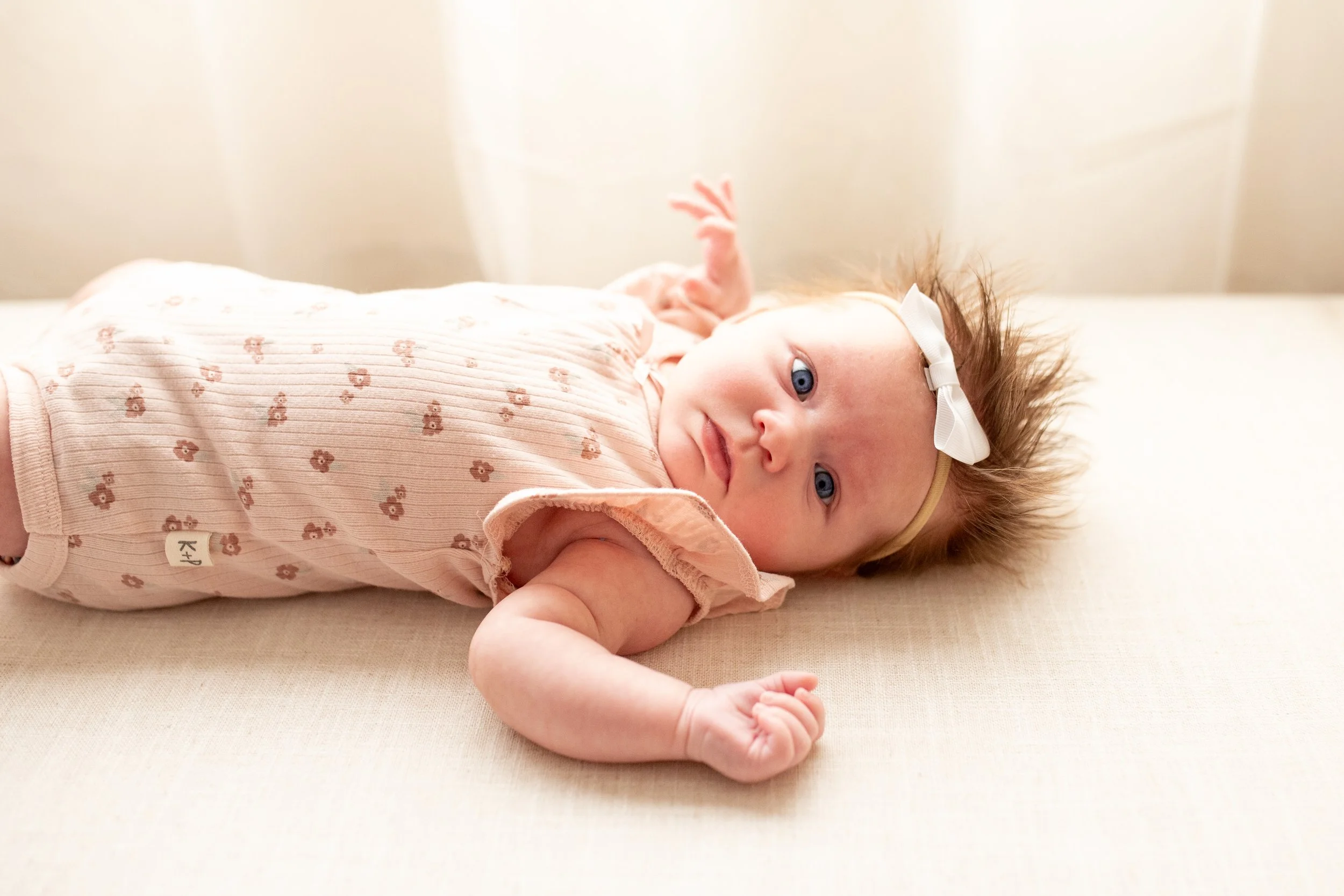 2 Month old baby smiles for the camera in natural light studio in downtown Bozeman, MT. Wanderbirth Photo, Mikaela DiBerardinis