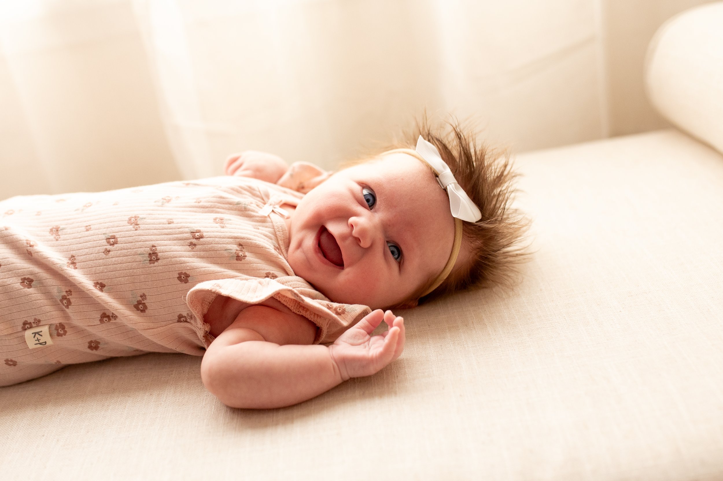 2 Month old baby smiles for the camera in natural light studio in downtown Bozeman, MT. Wanderbirth Photo, Mikaela DiBerardinis