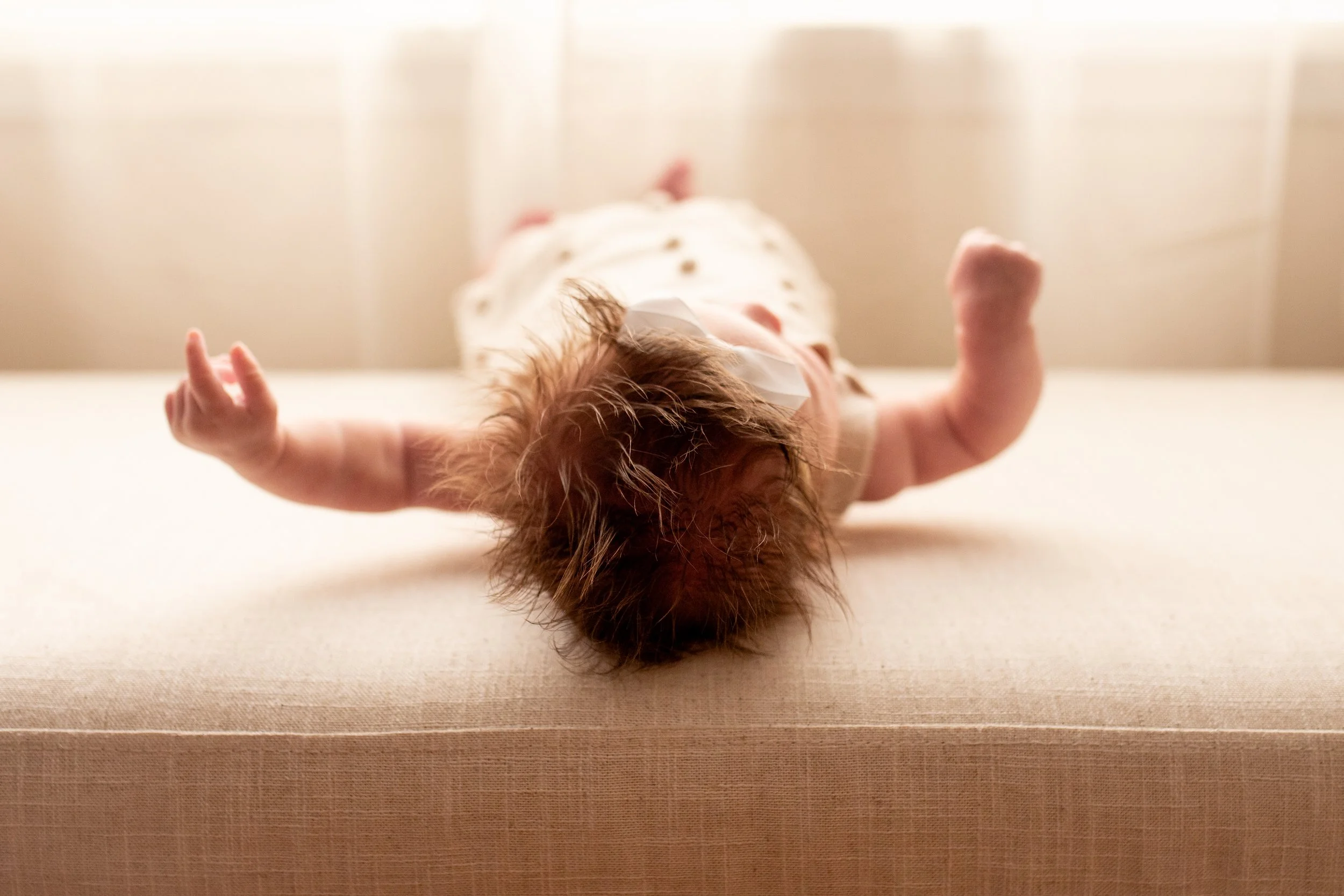 2 Month old baby smiles for the camera in natural light studio in downtown Bozeman, MT. Wanderbirth Photo, Mikaela DiBerardinis
