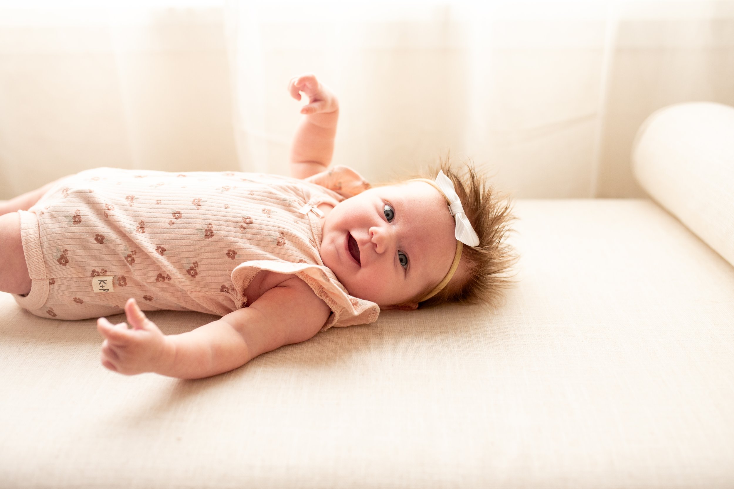 2 Month old baby smiles for the camera in natural light studio in downtown Bozeman, MT. Wanderbirth Photo, Mikaela DiBerardinis