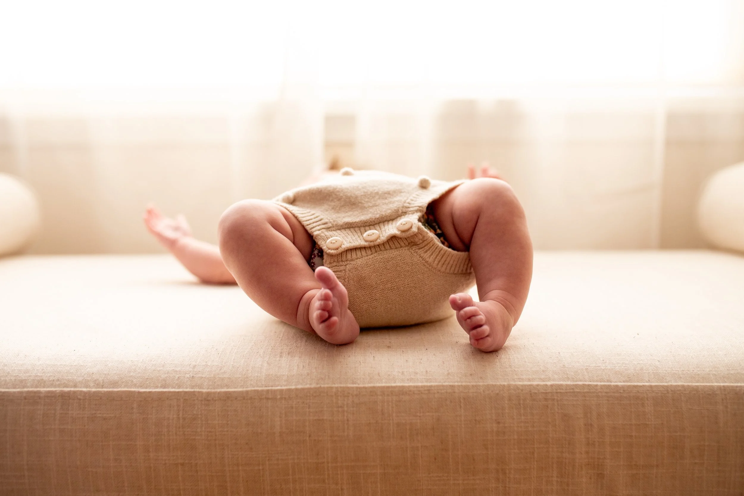 2 Month old baby smiles for the camera in natural light studio in downtown Bozeman, MT. Wanderbirth Photo, Mikaela DiBerardinis