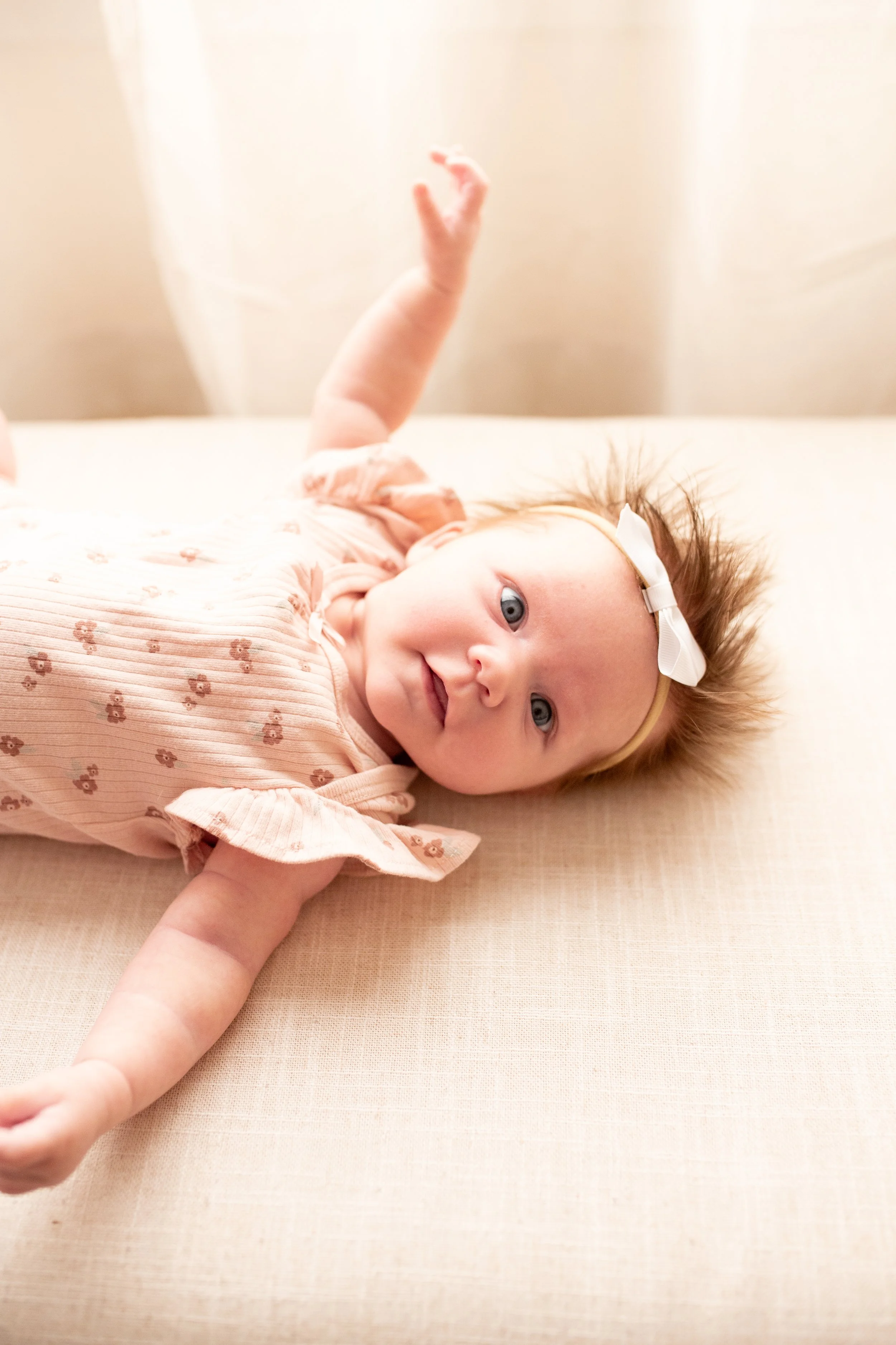 2 Month old baby smiles for the camera in natural light studio in downtown Bozeman, MT. Wanderbirth Photo, Mikaela DiBerardinis