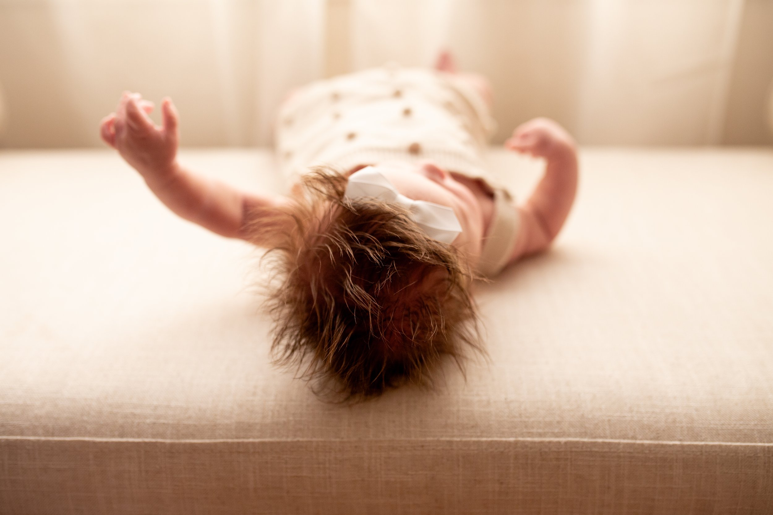 2 Month old baby smiles for the camera in natural light studio in downtown Bozeman, MT. Wanderbirth Photo, Mikaela DiBerardinis