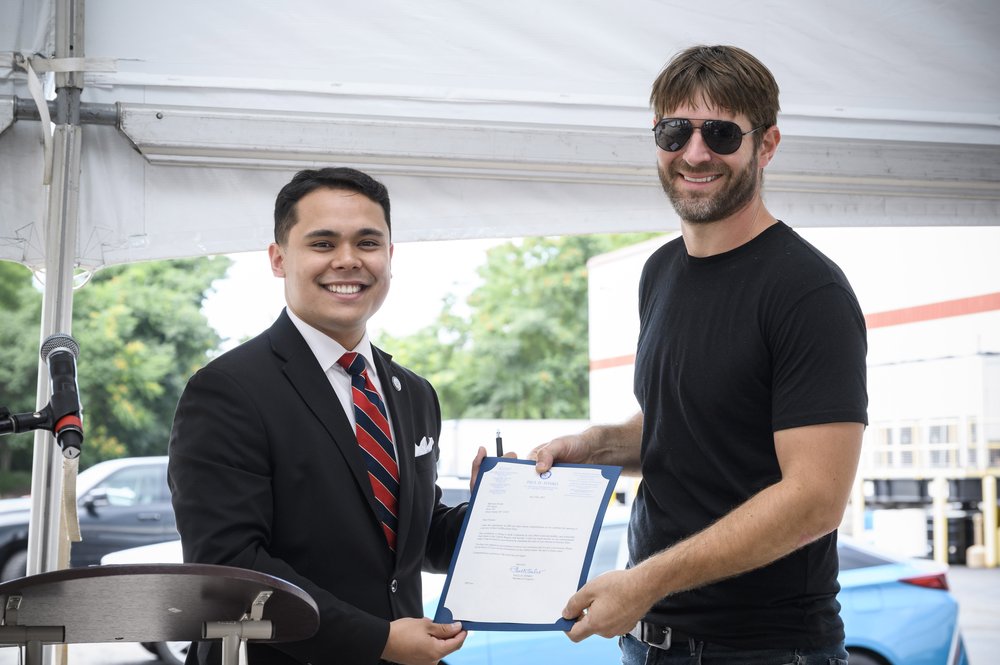  Manik presents Eben with a congressional letter of recognition and support. 
