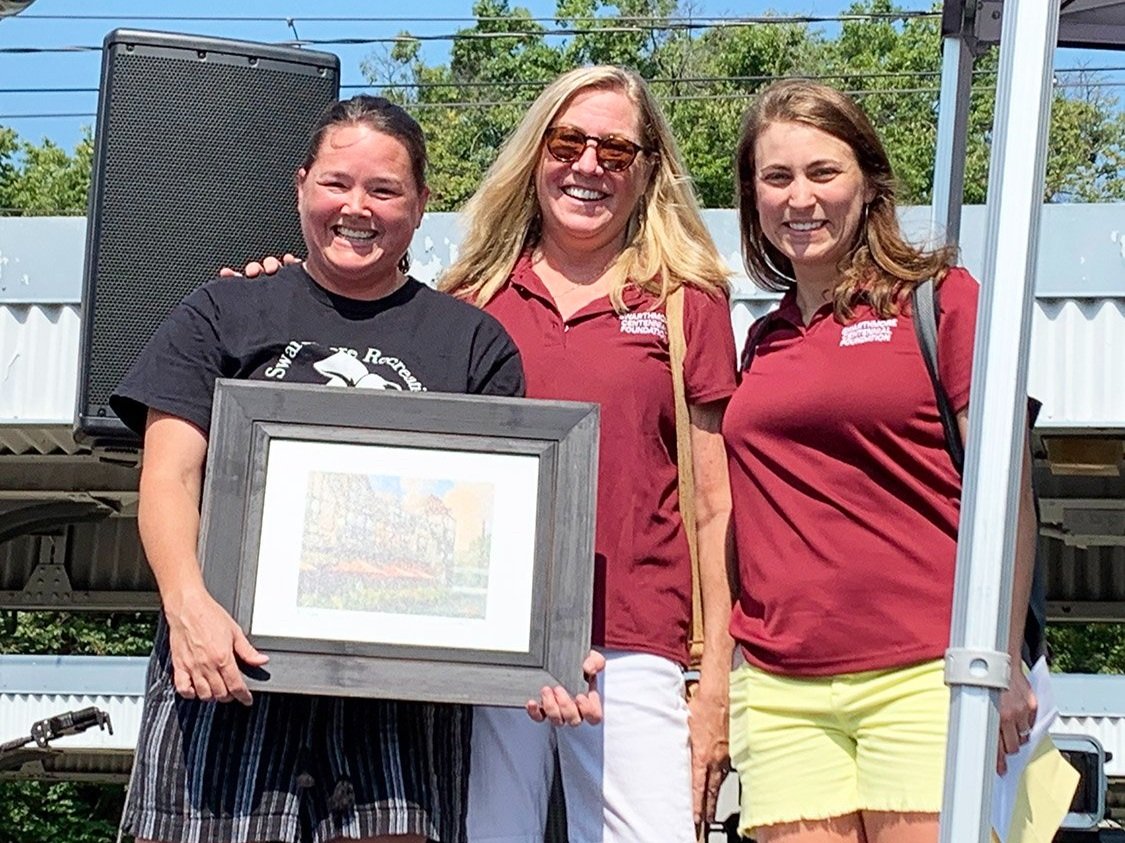 Sara Kelly wins "Shine a Light Award" pictured with A. Monica kruse and Katie McKinstry