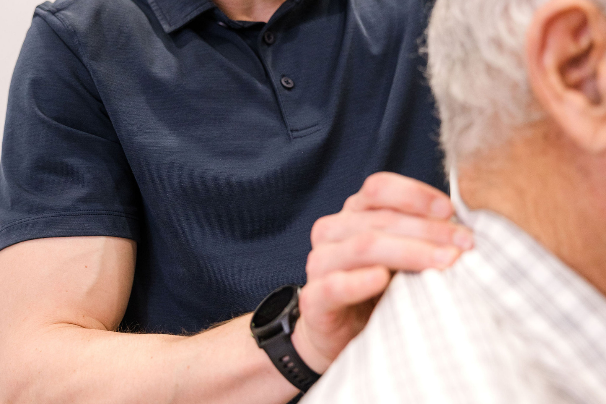 Chiropractor checking neck.