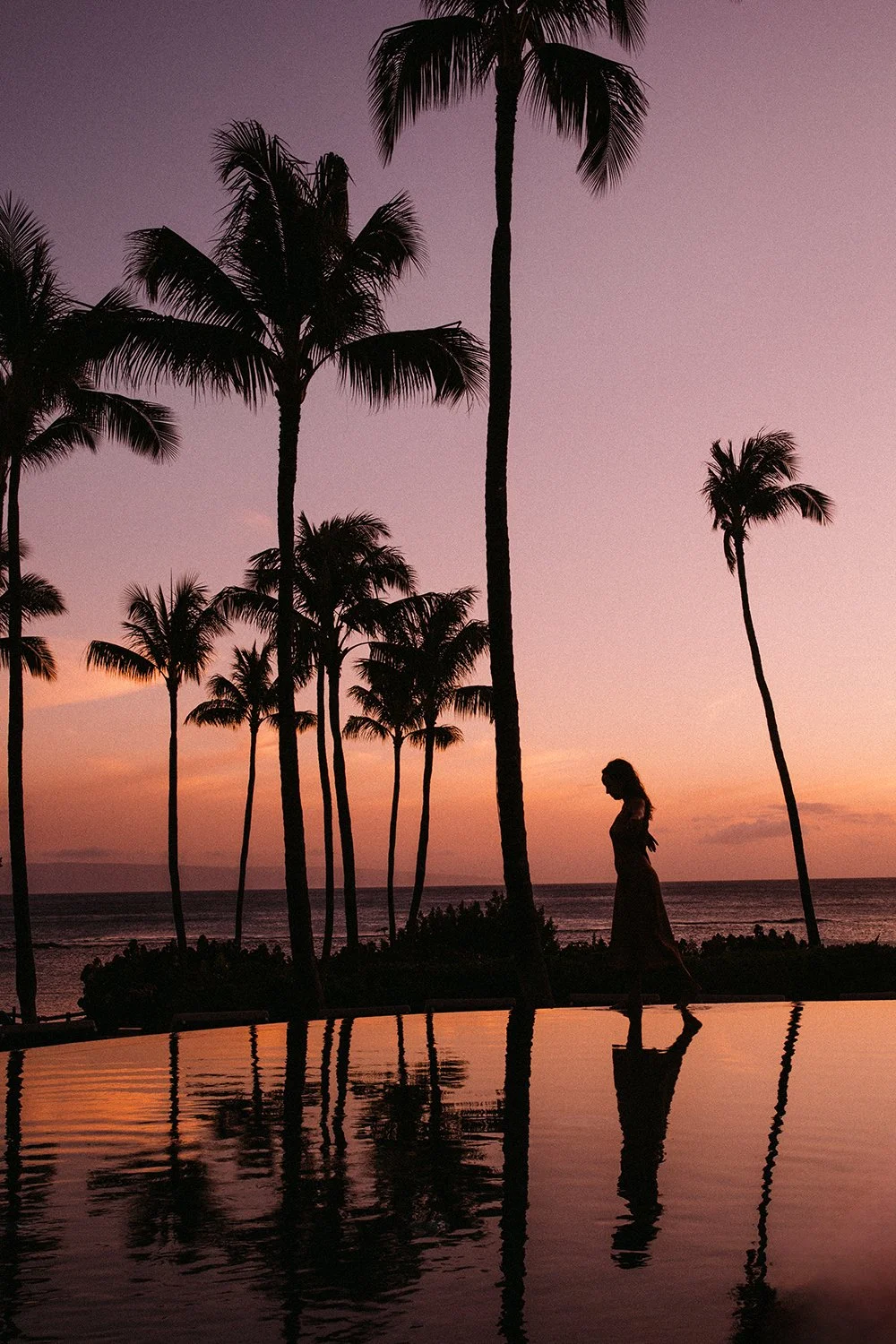 silhouette image of a woman with Lana'i behind her by Daeja Fallas for Travel and Leisure