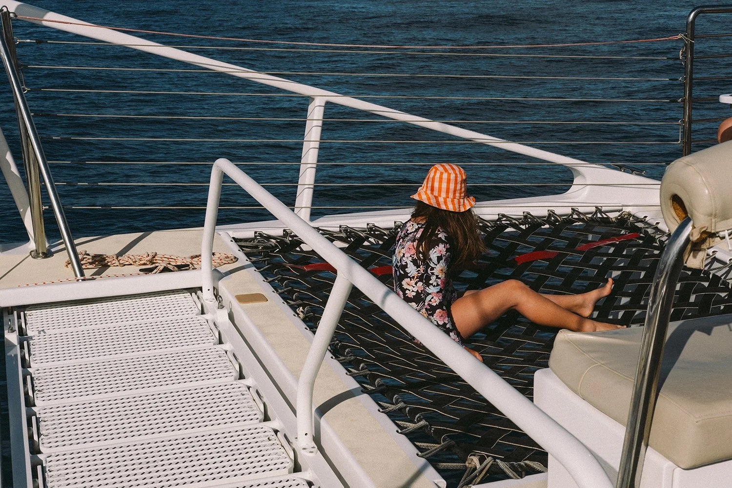 young girl looks out at the ocean off of Maui, Hawaii. Photography By Daeja Fallas for Travel + Leisure