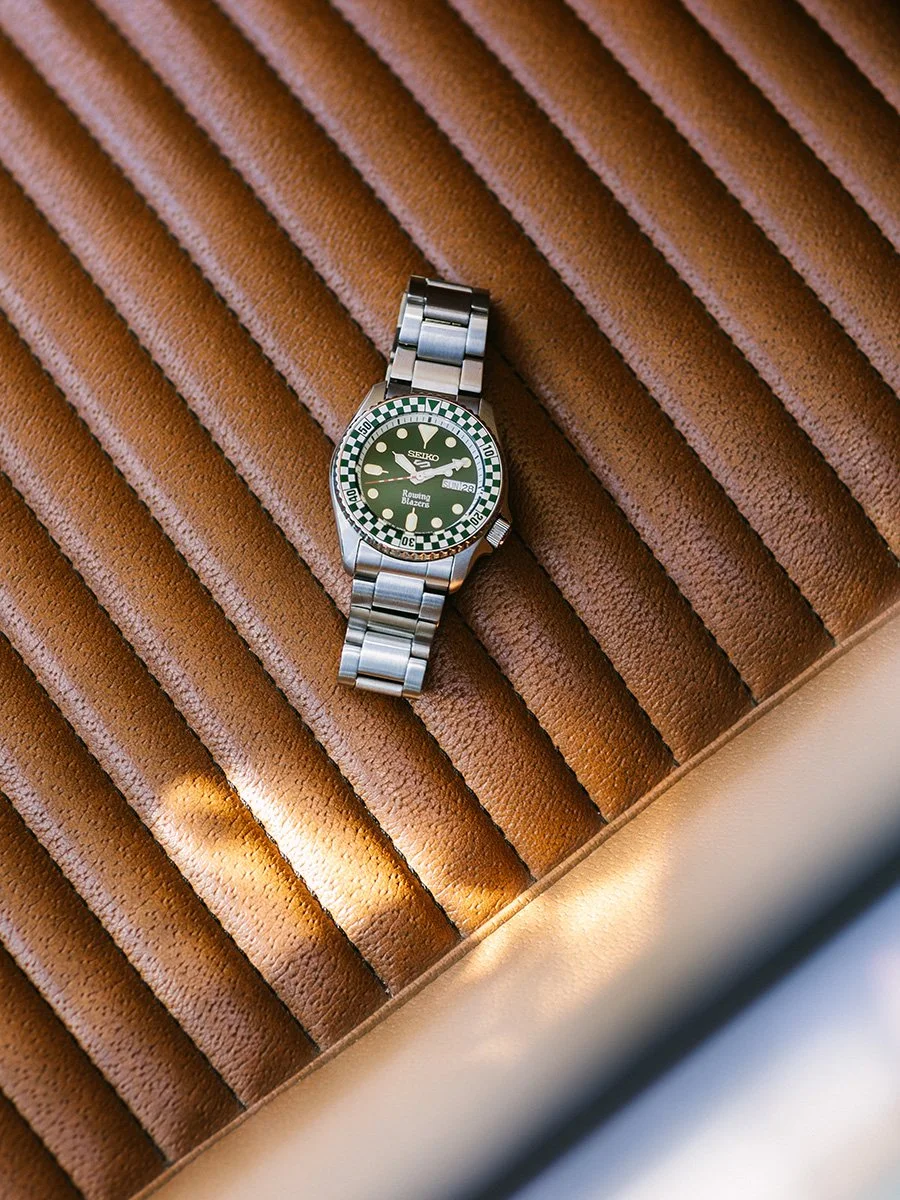 Seiko x Rowing Blazers racing watch detail on seat of vintage car, warm leather interior,, photography by Daeja Fallas.