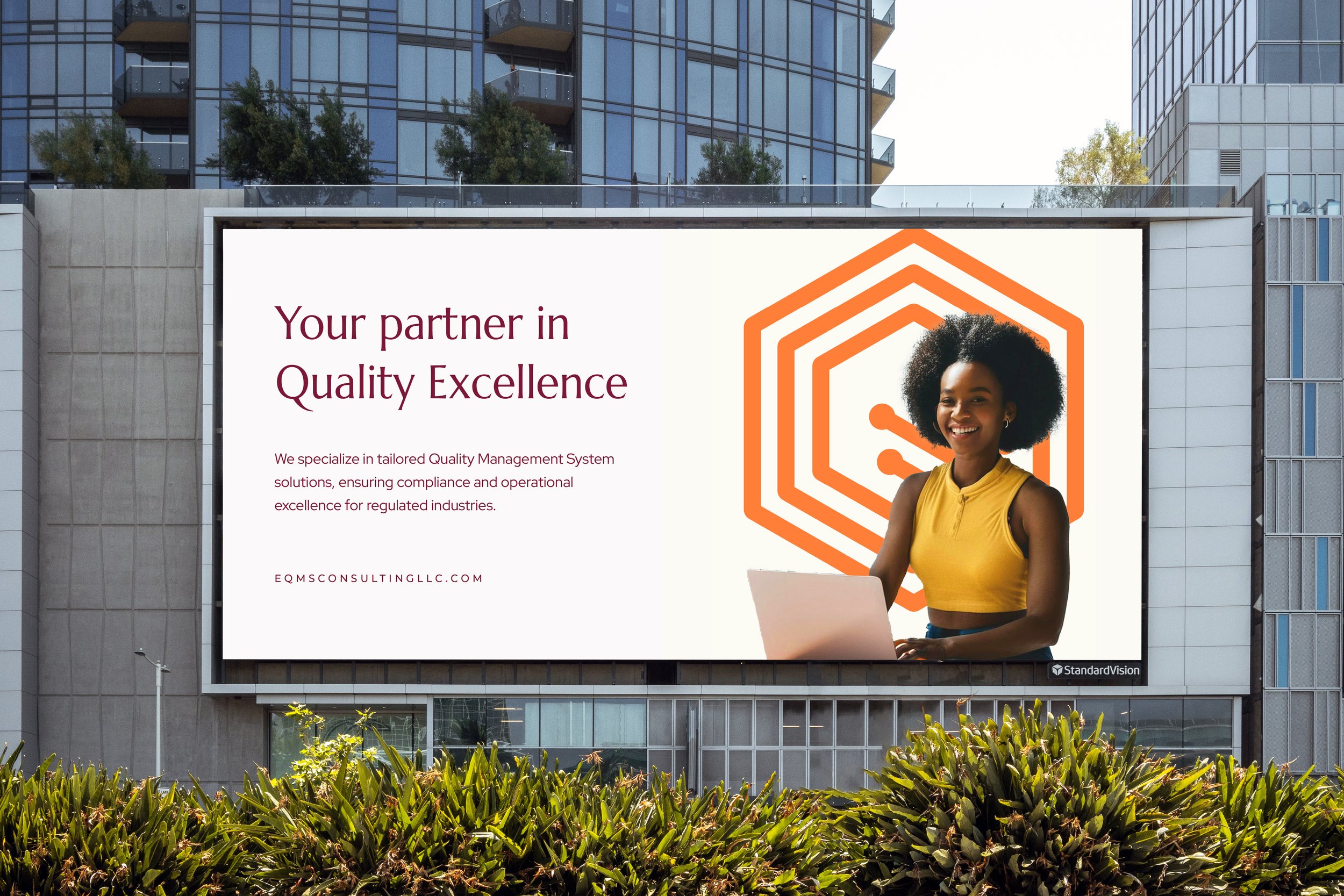 A large outdoor billboard showcasing a smiling woman in a yellow top working on a laptop, with an abstract orange logo in the background. The billboard promotes quality management system solutions and features the text: 'Your partner in Quality Excellence' and a website URL, EQMSConsultingLLC.com.