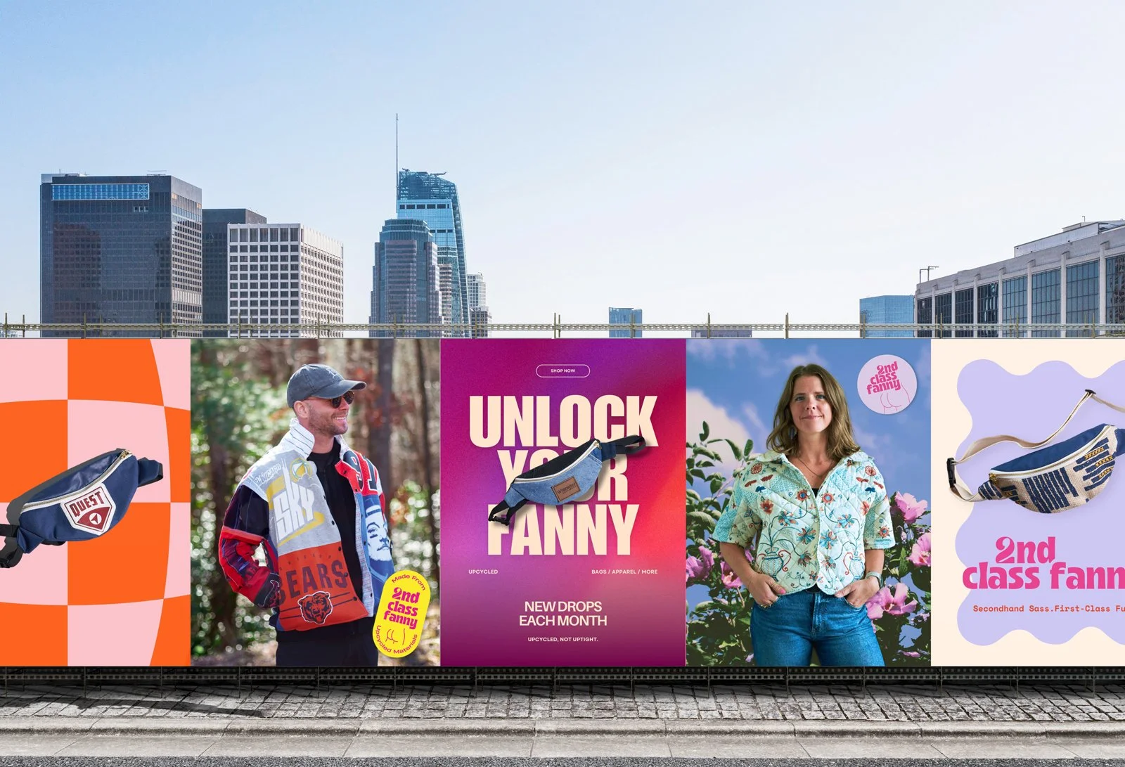Billboard advertisement featuring clothing and accessories, with images of people and promotional text for upcycled bags and apparel, and a city skyline in the background.
