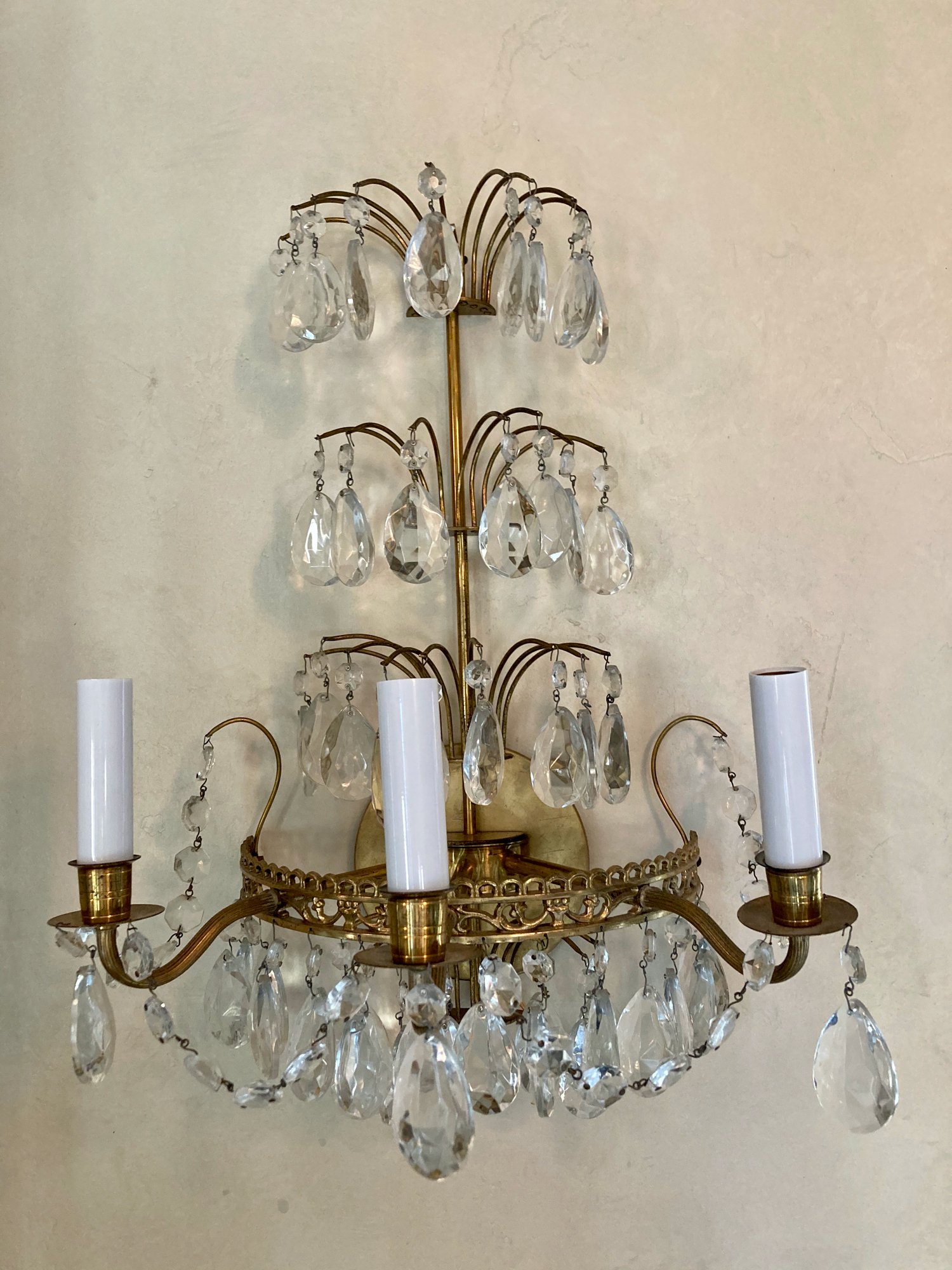 Gorgeous pair of Hollywood regency style 1950s brass and crystal three tier wall sconces.
Dimensions: 19" Wide x 12" High
Price: $2,100 pair