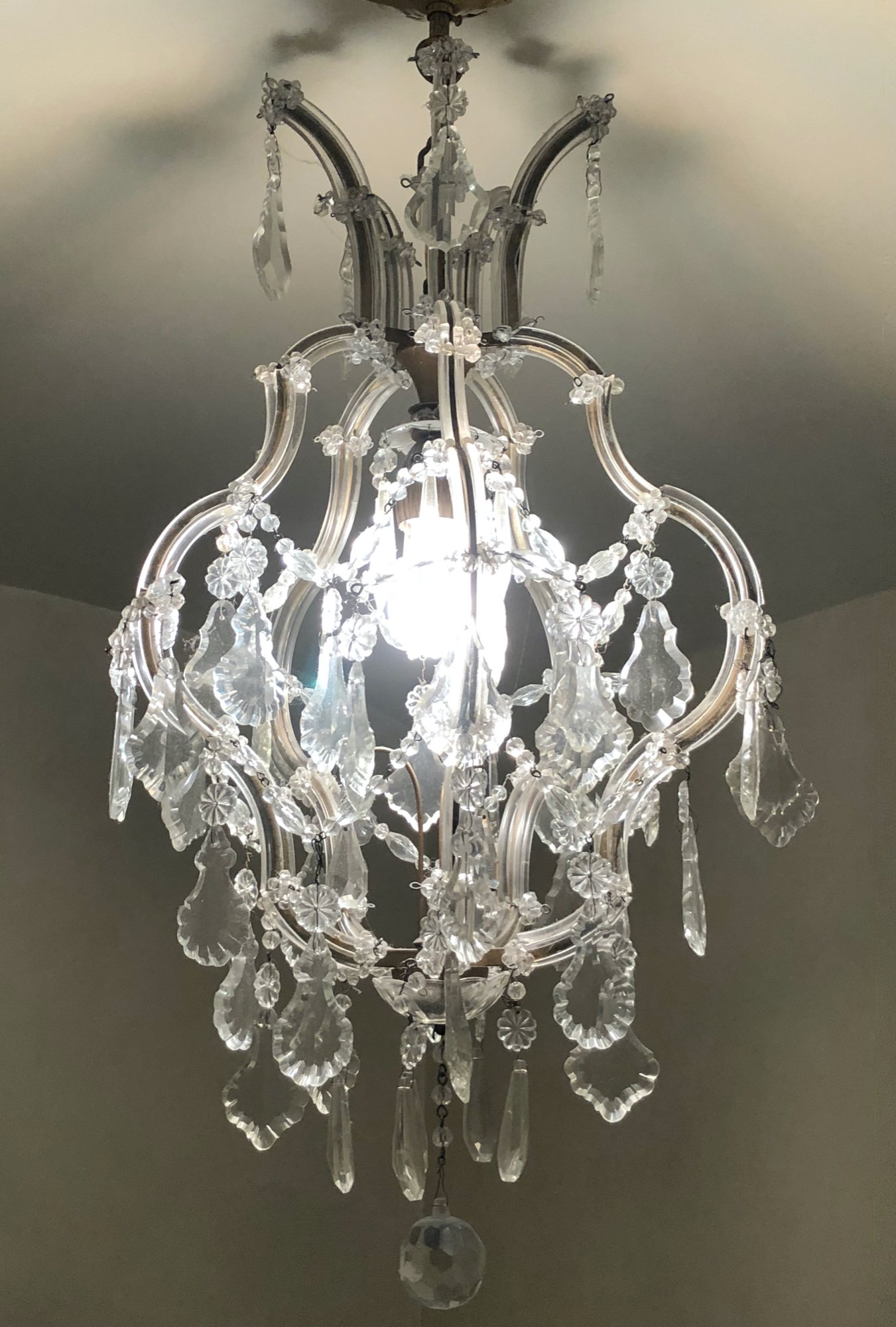 Gorgeous Italian 1930s crystal and brass birdcage chandelier.
Dimensions: 27" tall x 14" wide
Price: $3,200