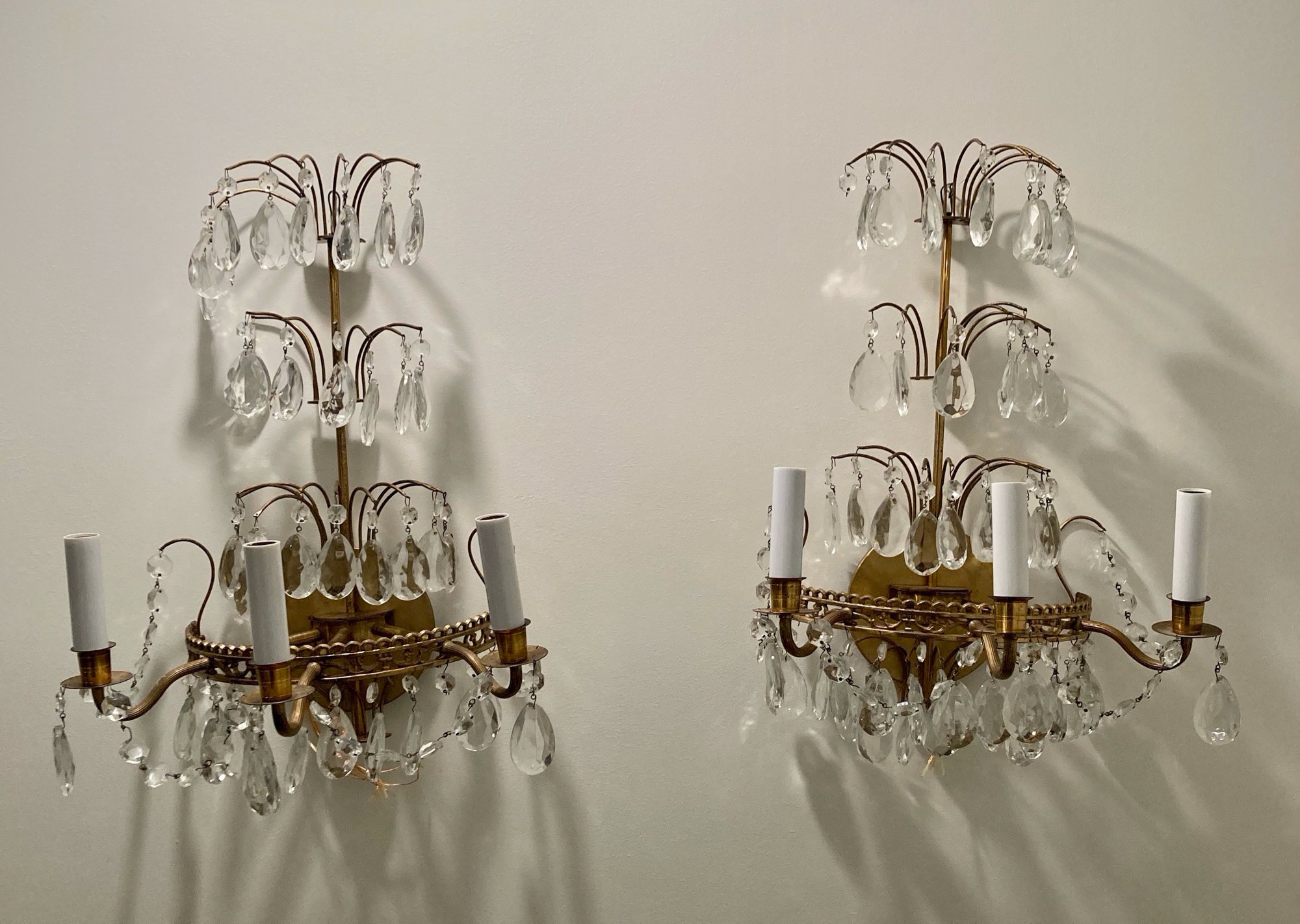 Gorgeous pair of Hollywood regency style 1950s brass and crystal three tier wall sconces.
Dimensions: 19" Wide x 12" High
Price: $2,100 pair
