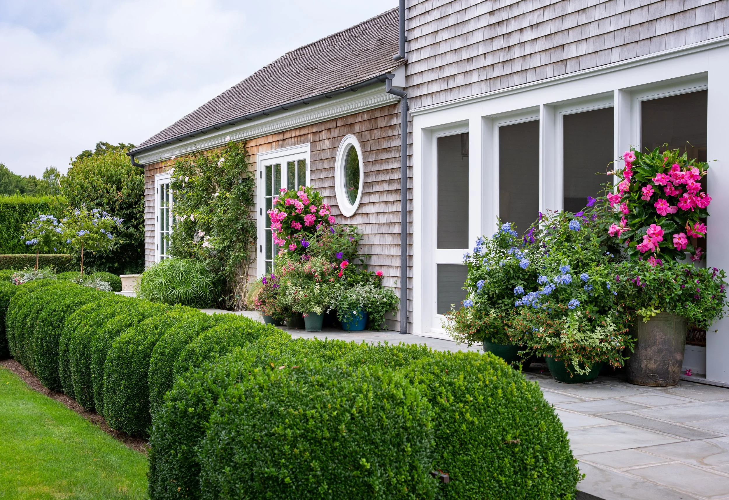 Garden in hamptons estate hedges flowers stone wood
