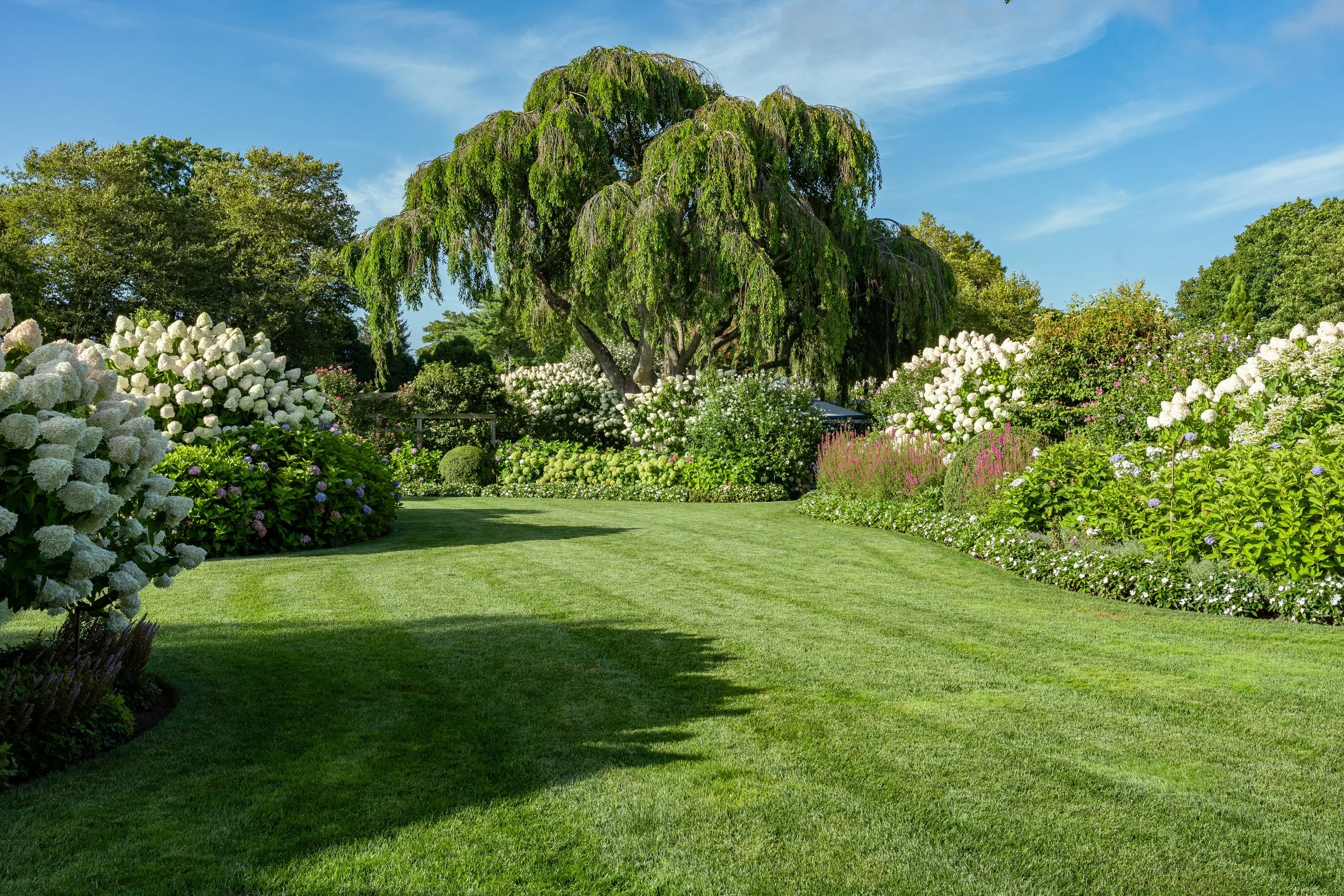 Lush hamptons garden estate trees flower oasis