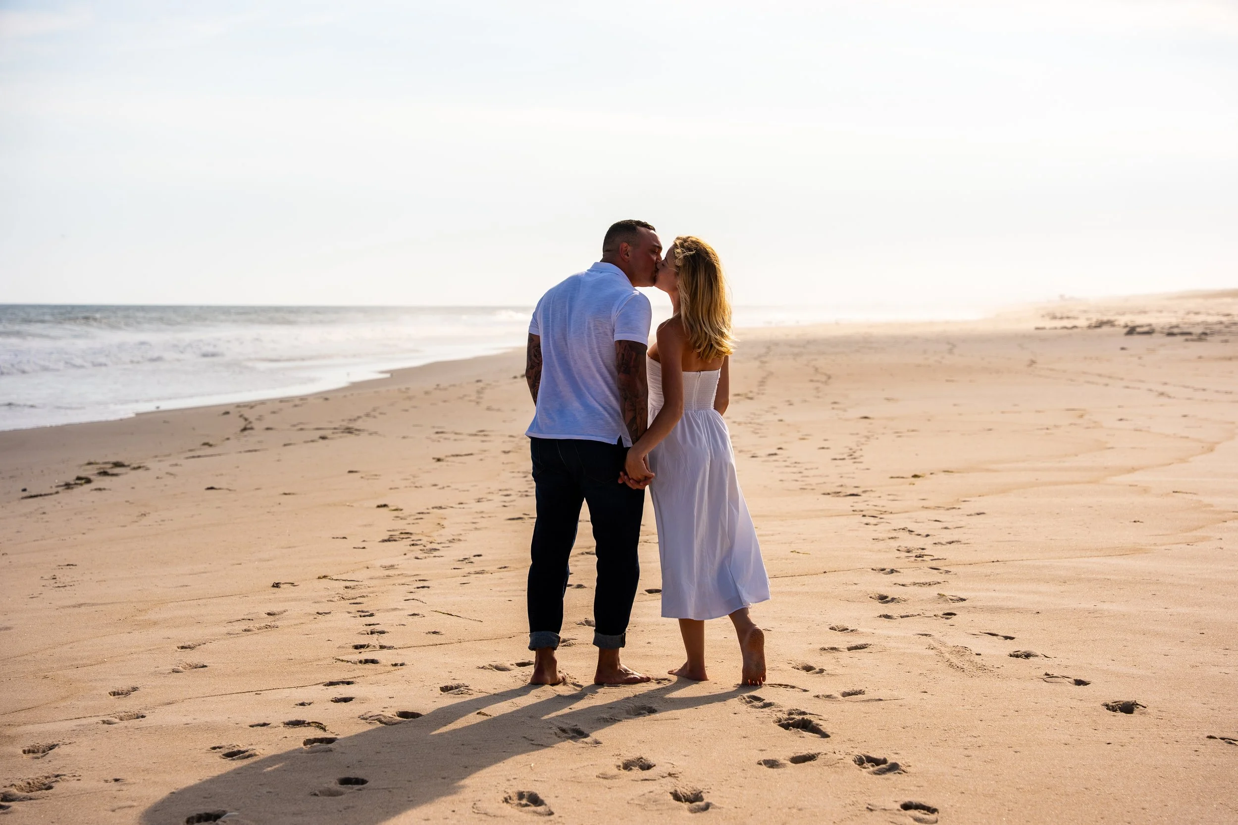 Couple kissing on the beach during a Hamptons portrait session