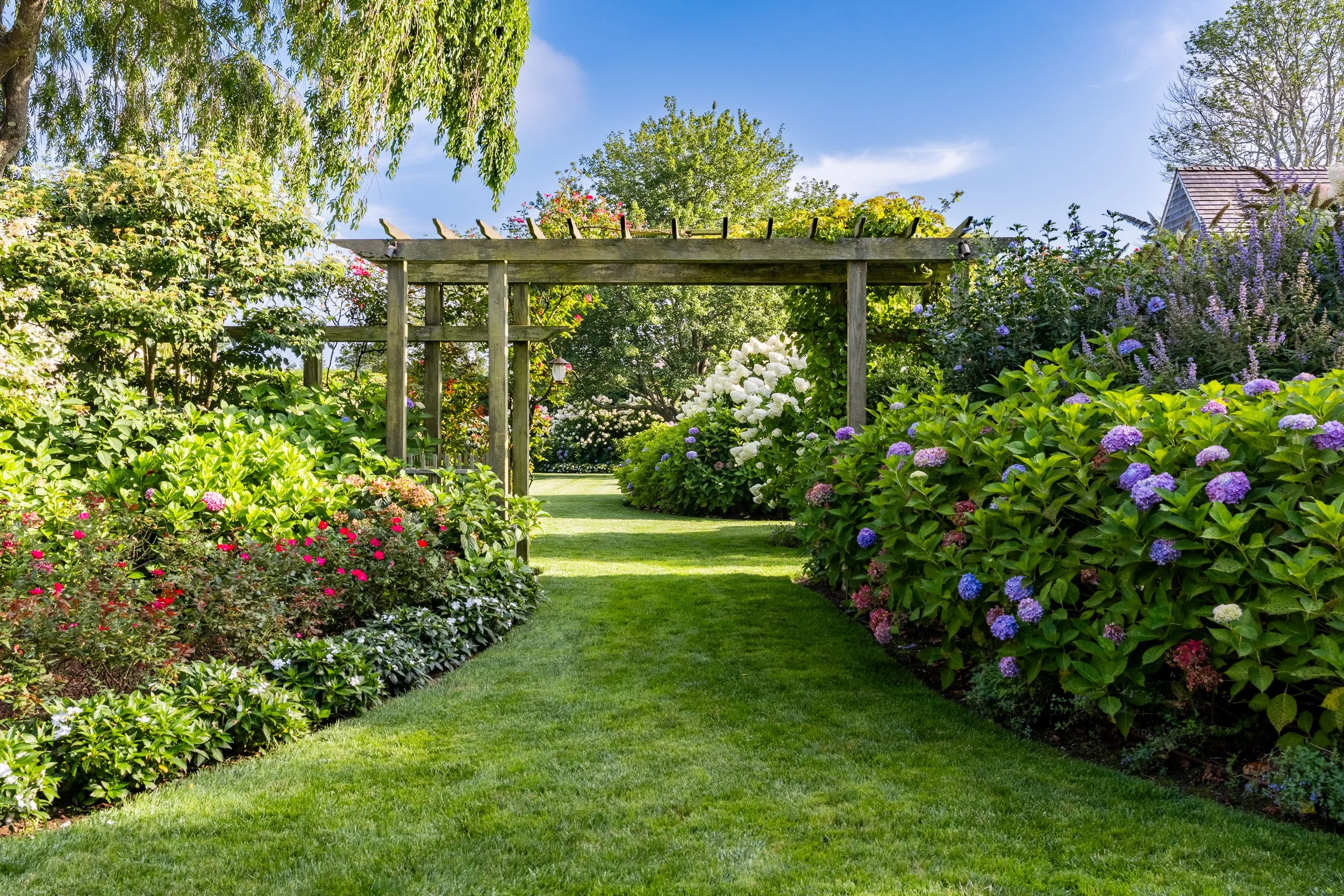 pergola hamptons estate flowers greenery blue skys
