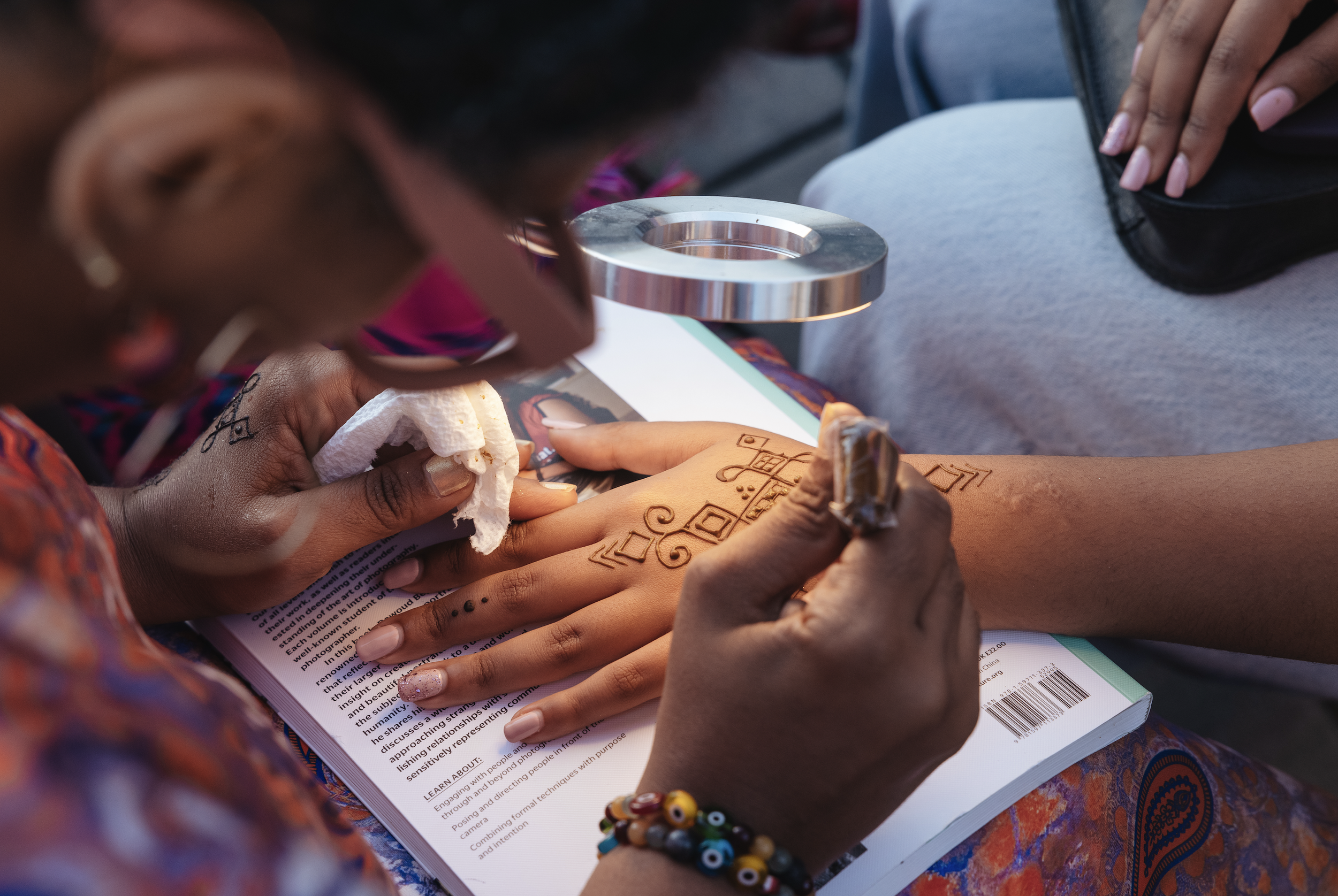 Live henna artist at opening reception—honoring cultural tradition