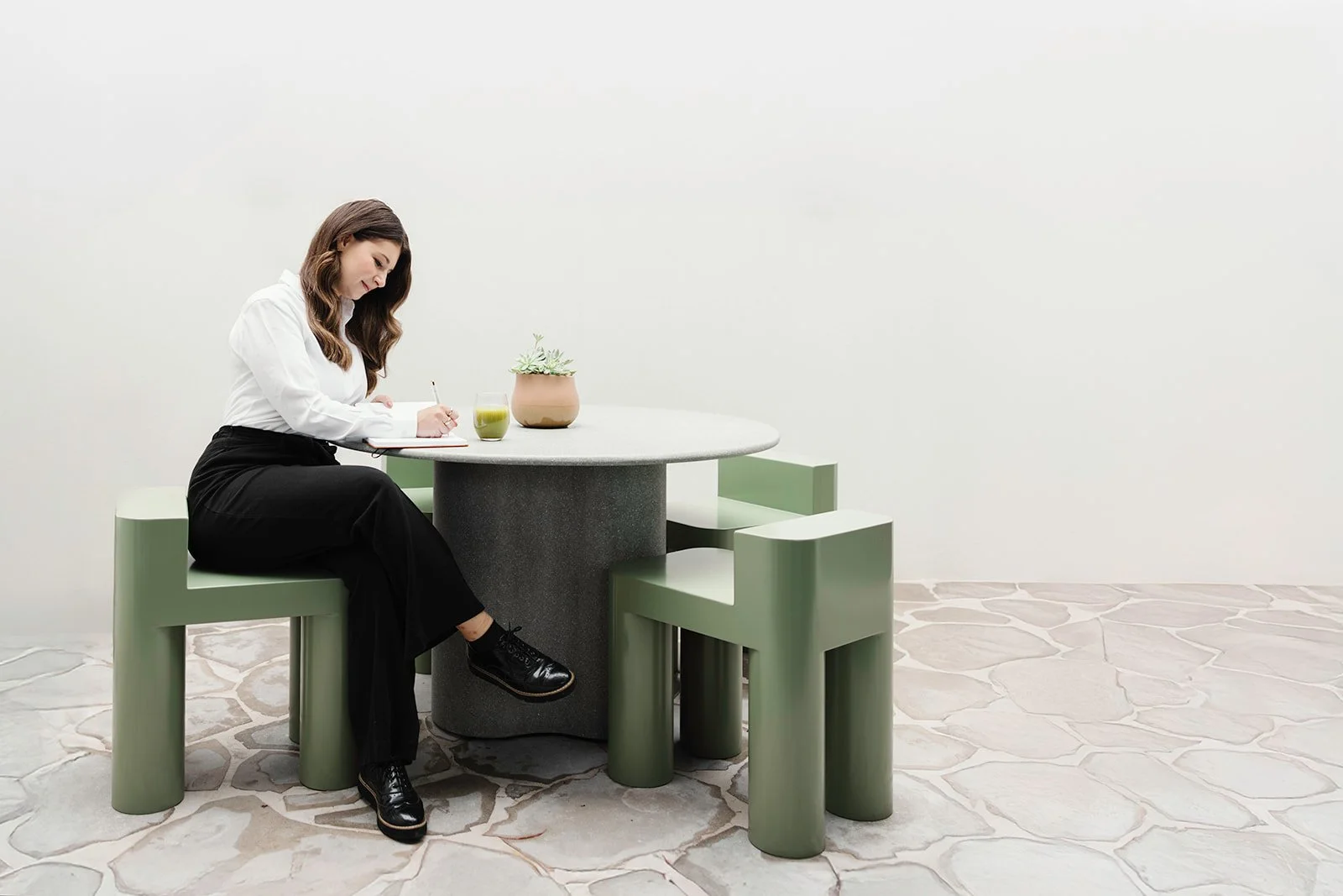 Person writing for inspiration away from screen