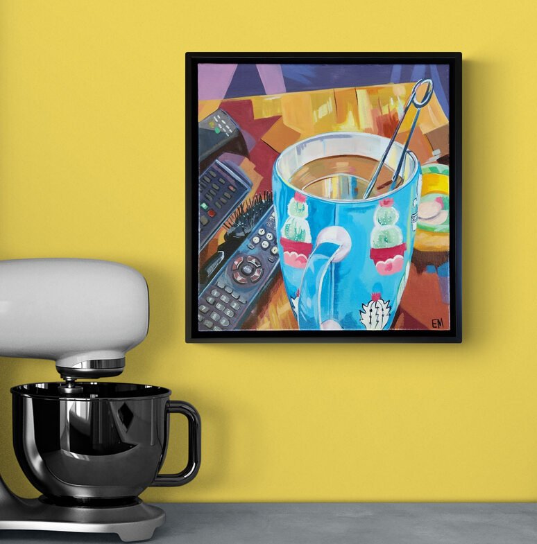 Coffee cup art hanging on yellow wall