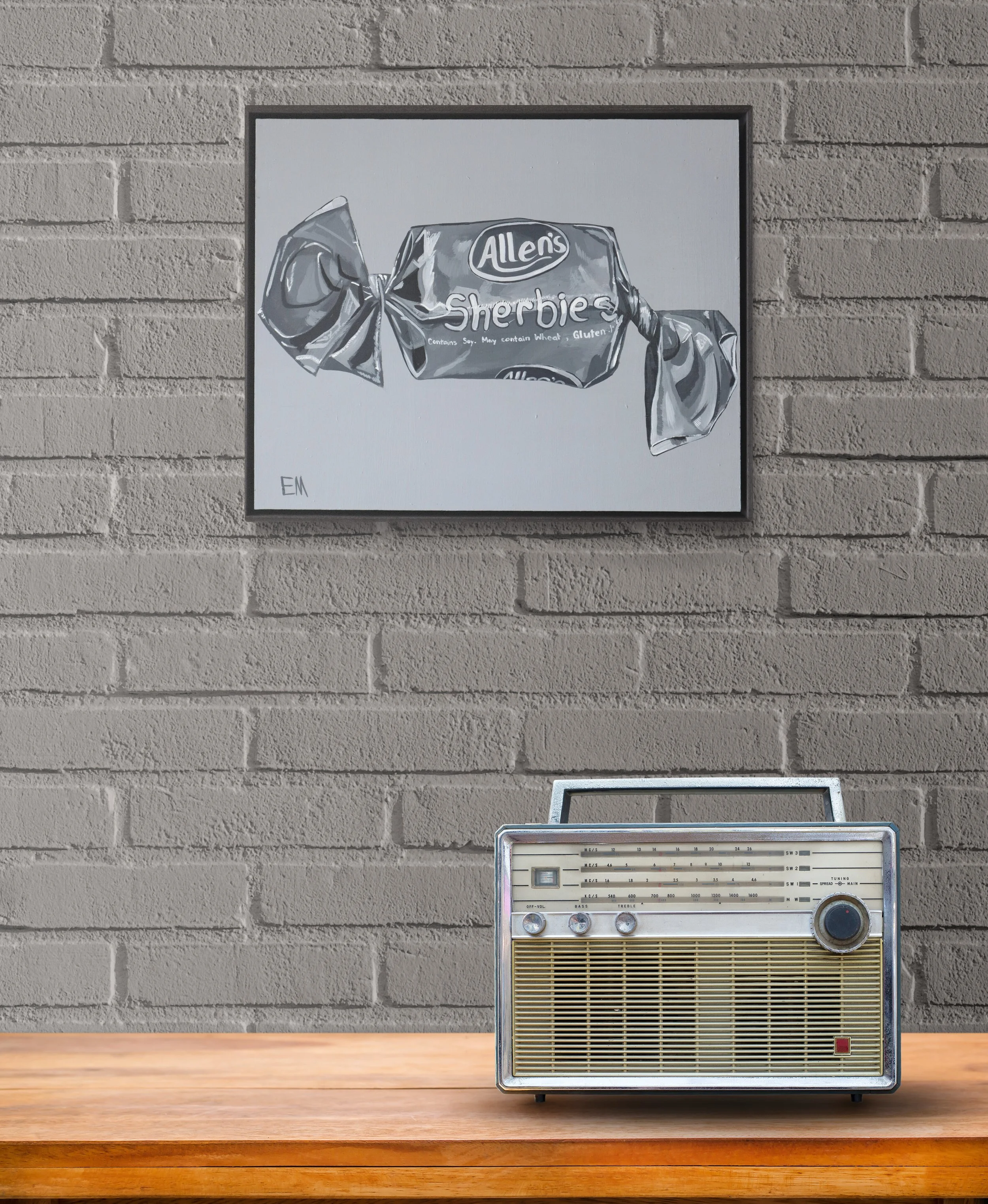 Grey Sherbie Artwork Hangs On Wall With Grey Brick and radio