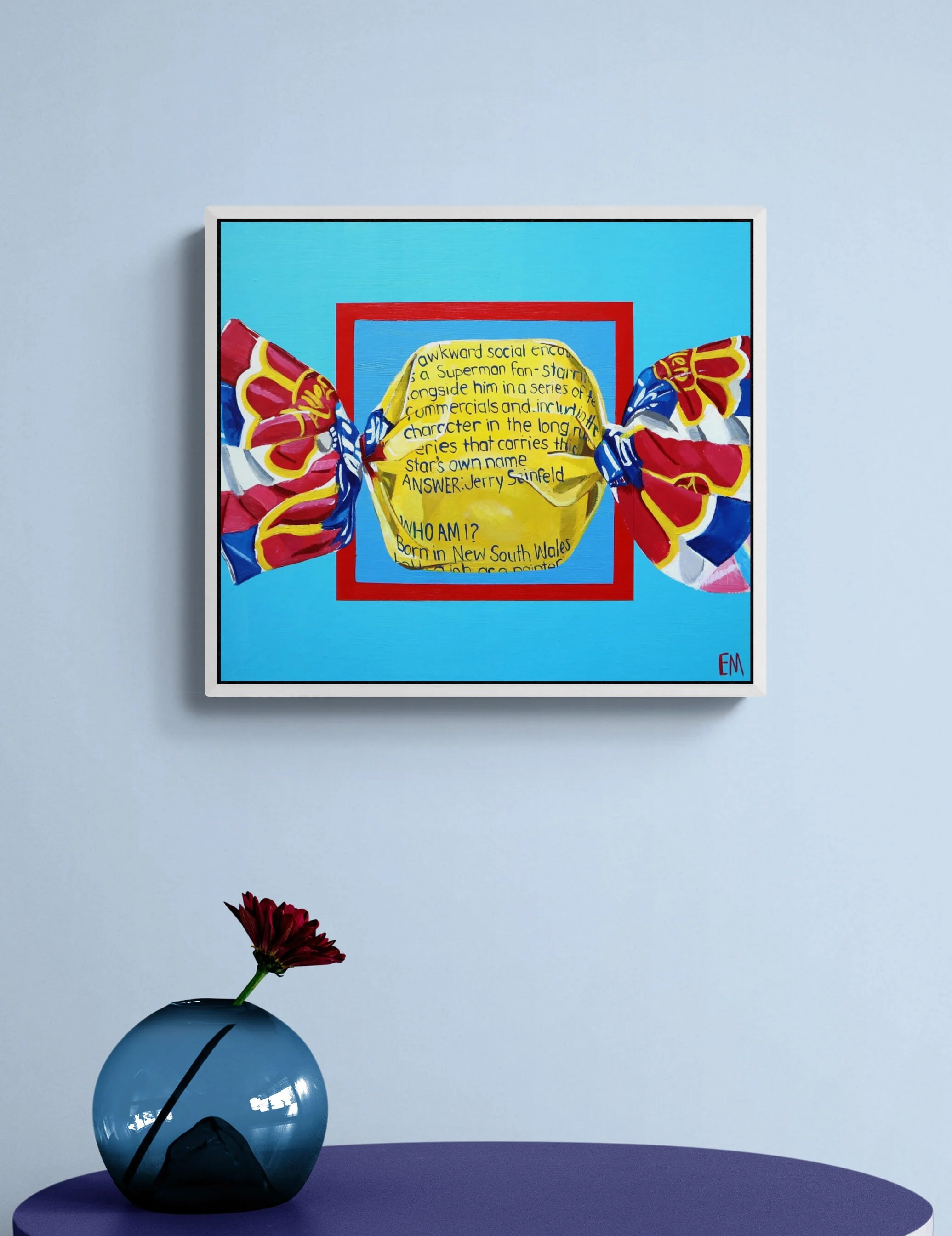lolly art hanging on wall displayed in blue room