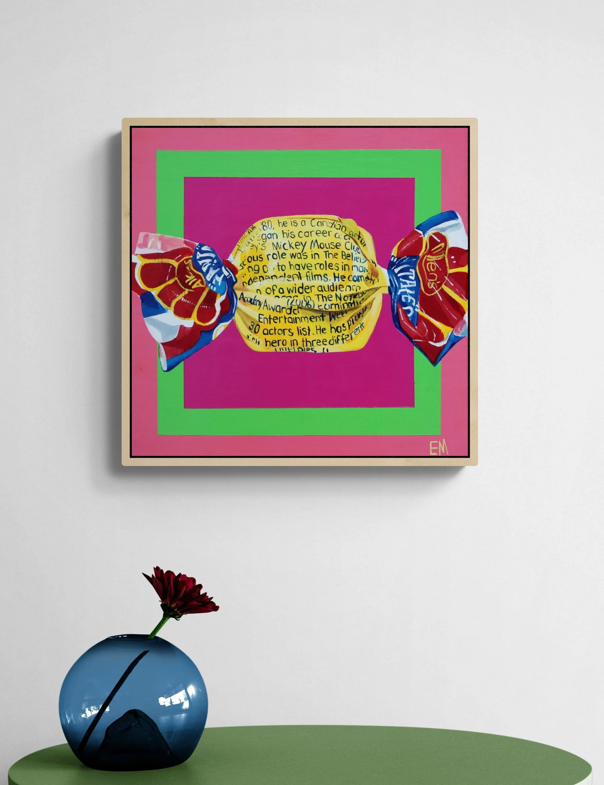 framed pink art work displayed on wall
