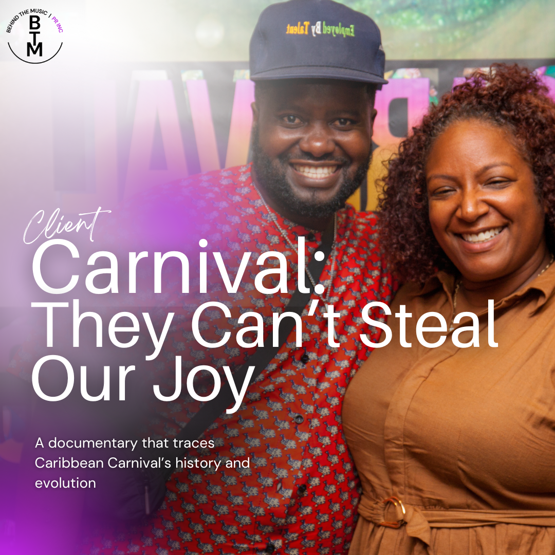 Two smiling individuals, a man and a woman, posing at a Caribbean Carnival event with colorful background decorations.
