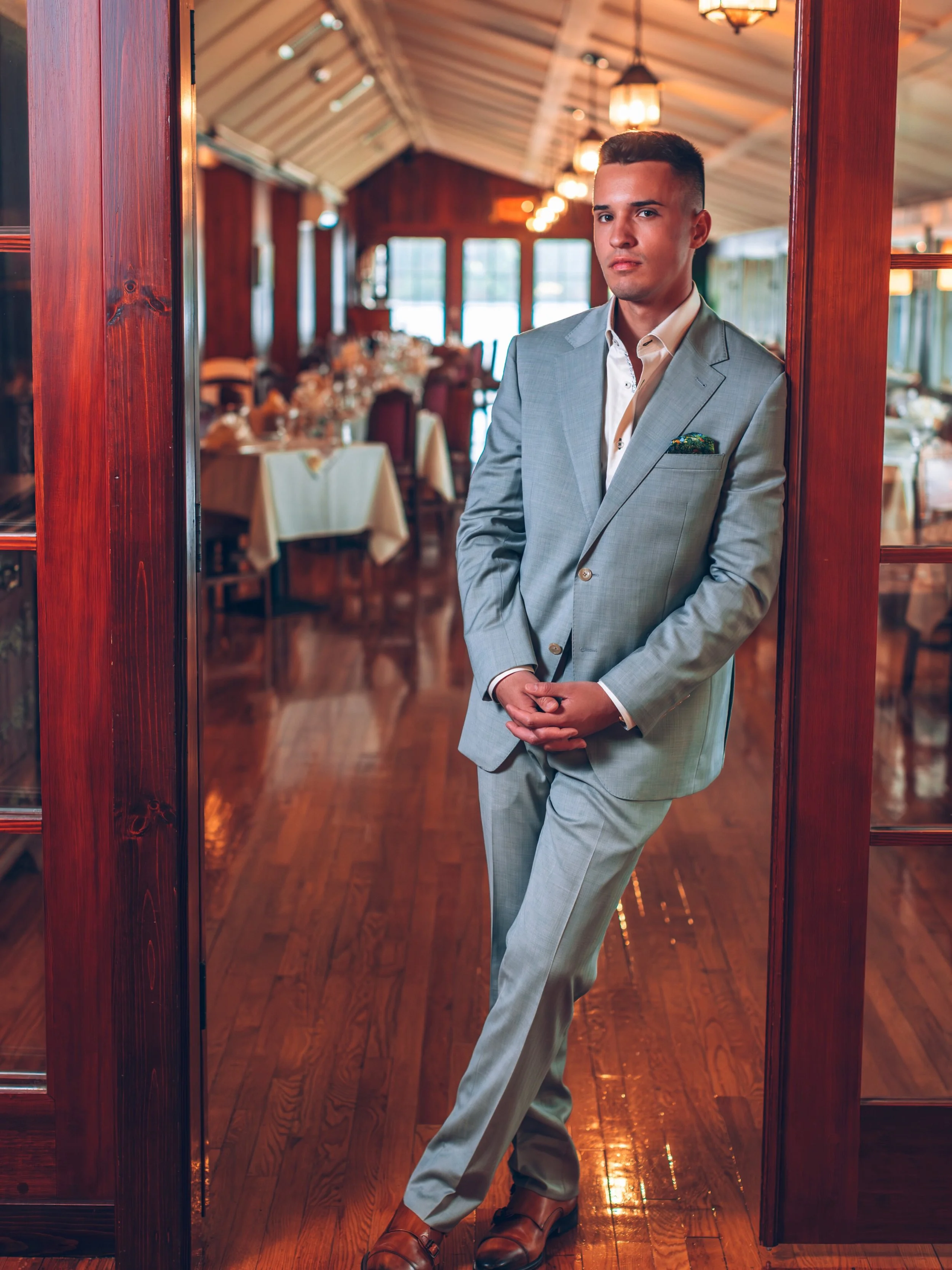 Most wedding parties go blue. This one didn&rsquo;t.

The groom&rsquo;s sage herringbone, single breasted, two-piece suit set the tone. 

Open collar for summer, with green and floral accents at the collar and buttons.

An Artwork Series pocket squar