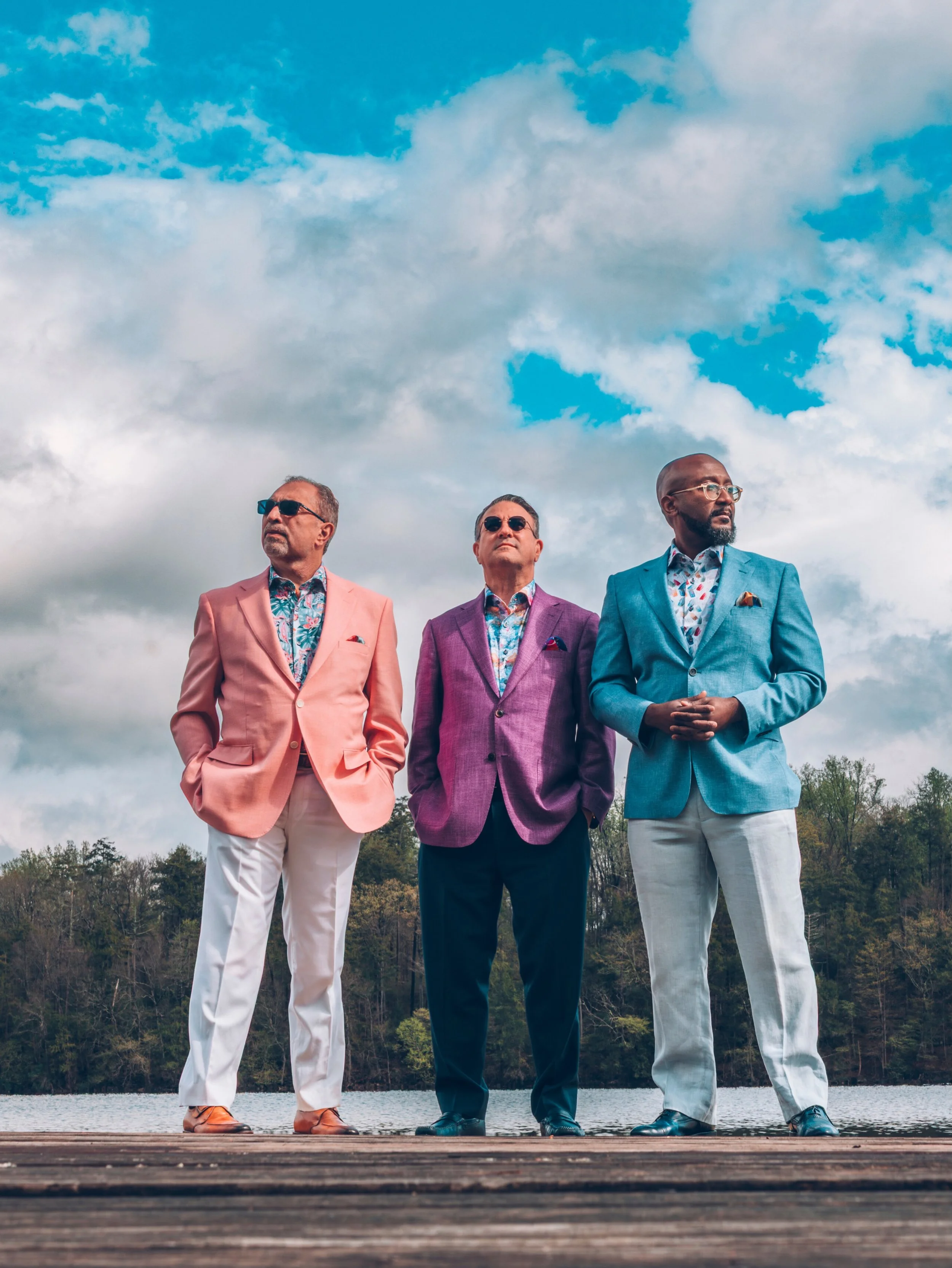 Three wedding guests.
Three different palettes.
One very nice view.

The fit breakdown from left to right:

Richard in a pink hopsack jacket, peacock and floral print short sleeve &amp; cream slacks.

Max in a lavender bamboo jacket, watercolor short