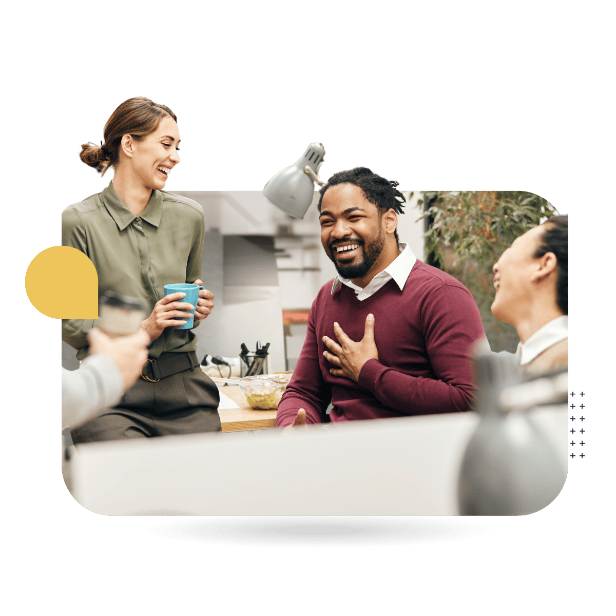 Three coworkers laughing and chatting together in a modern office break area, representing CultureAlly Workplace and corporate training.