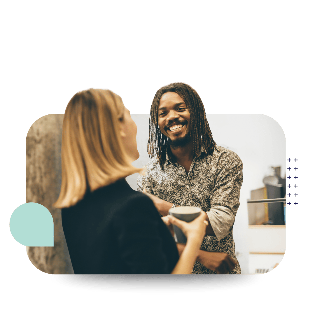 Two people having a discussion, smiling while having a beverage representing Psychological Safety