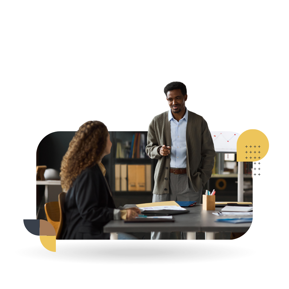 Two people in conversation in an office, representing CultureAlly Leadership Development Experience