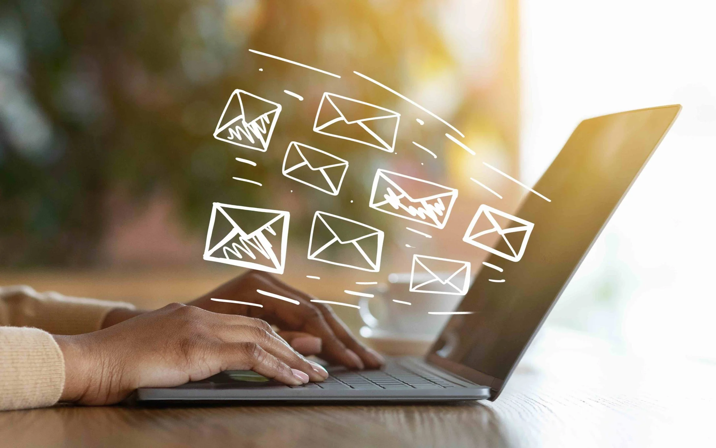 Image of hands on a laptop sending an email