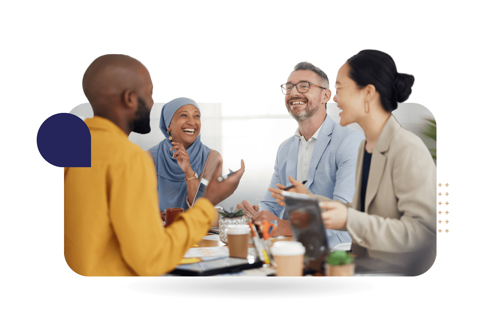 Four people having a meeting at a table, discussing CultureAlly's DEI Foundations Training