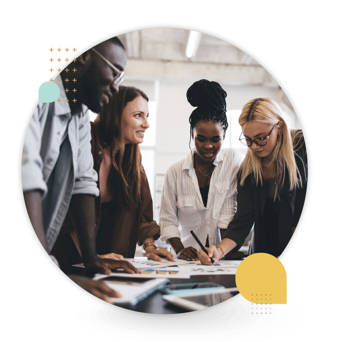 A diverse group of four coworkers collaborates around a table in a bright office, reviewing documents and writing notes together.