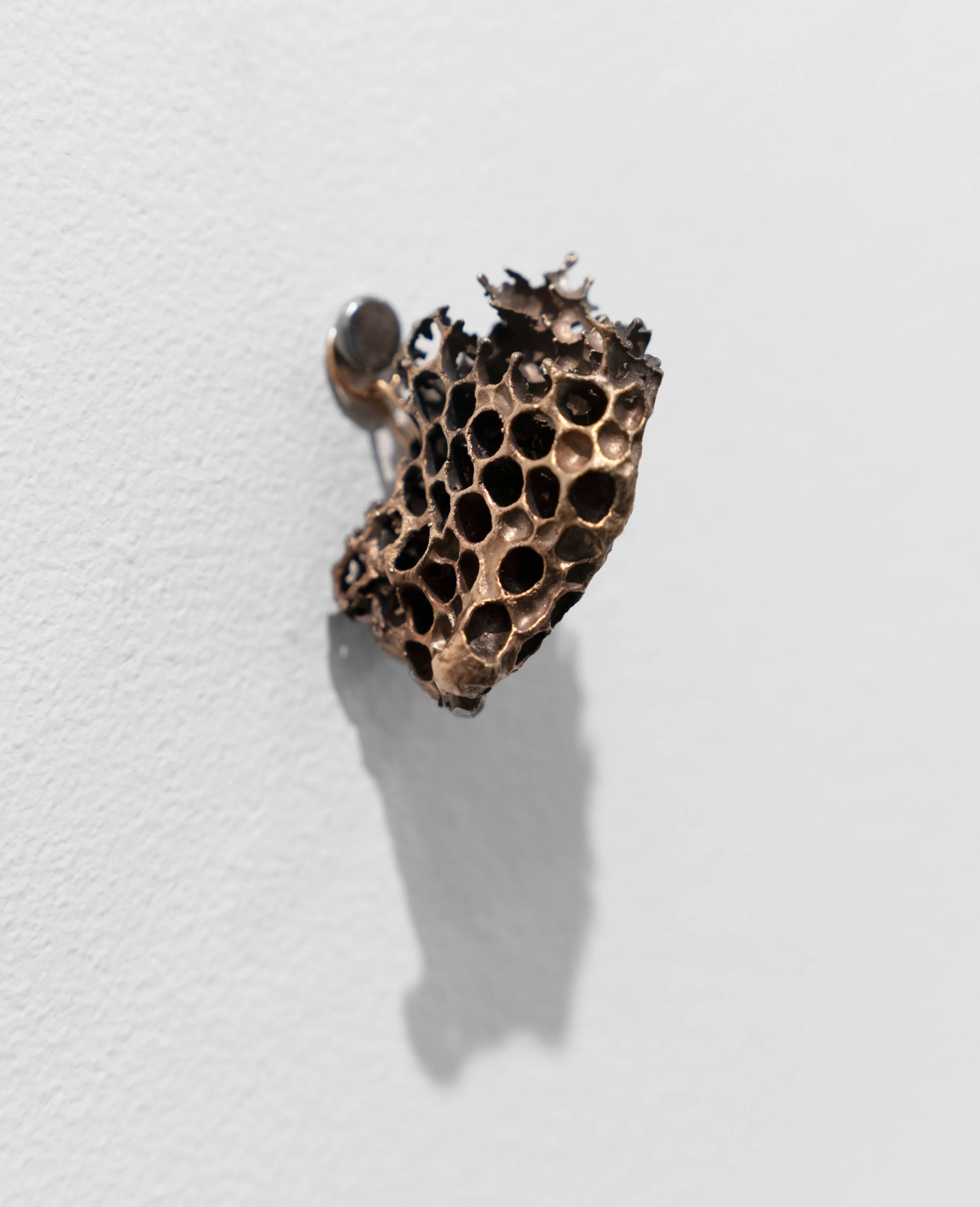 Queen Cell
bronze, lost wax was honeycomb with queen cell, indicating the hive is getting ready to swarm and preparing for a new queen 
1.5” x 1.5” x 2”
