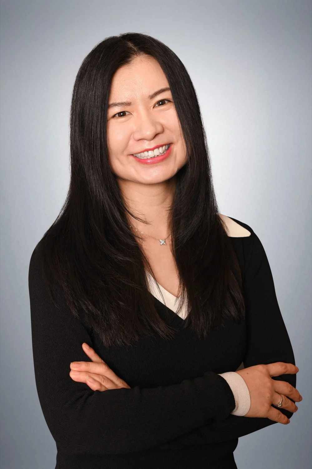 Claire Li, Psychotherapy Intern at Rachel Parodneck & Associates Psychotherapy, smiling in a black v-neck sweater
