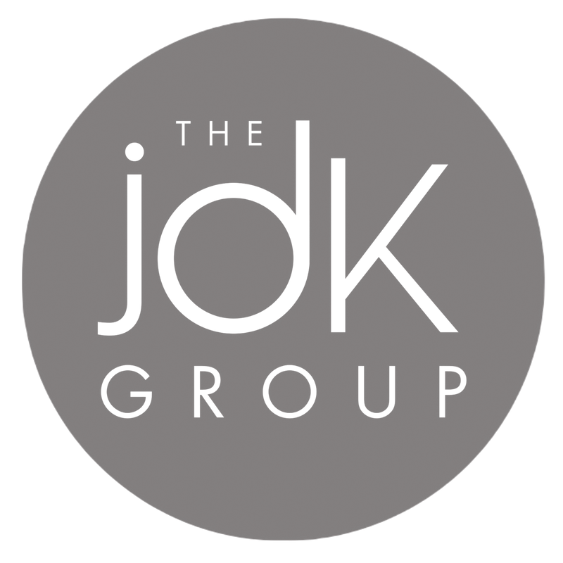 The logo for the JDK Group, featuring the text 'THE jdk GROUP' in black on a gray circular background.
