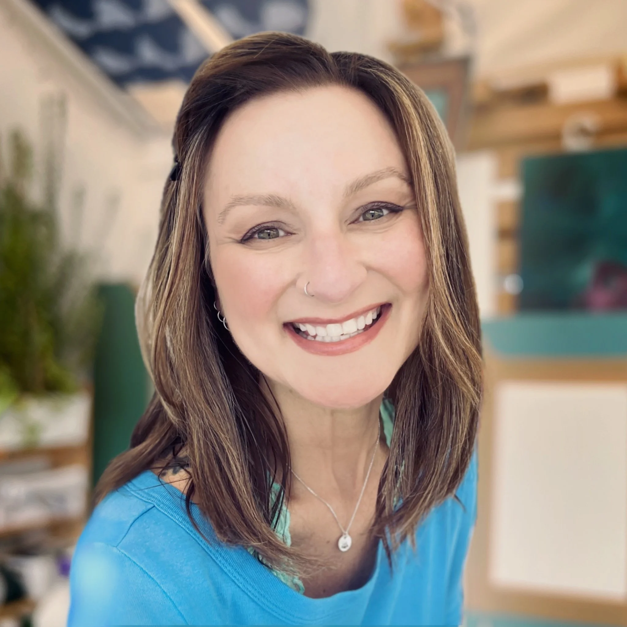 Jen Dixon is smiling in her art studio