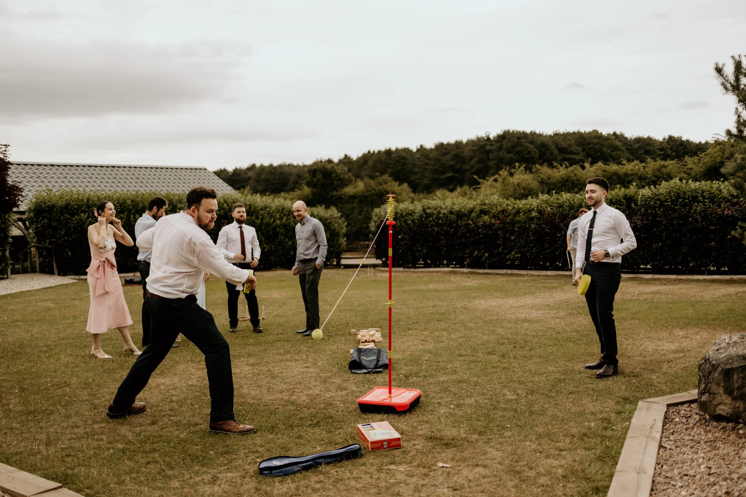 A relaxed wedding day shot of wedding guests playing garden games at venue