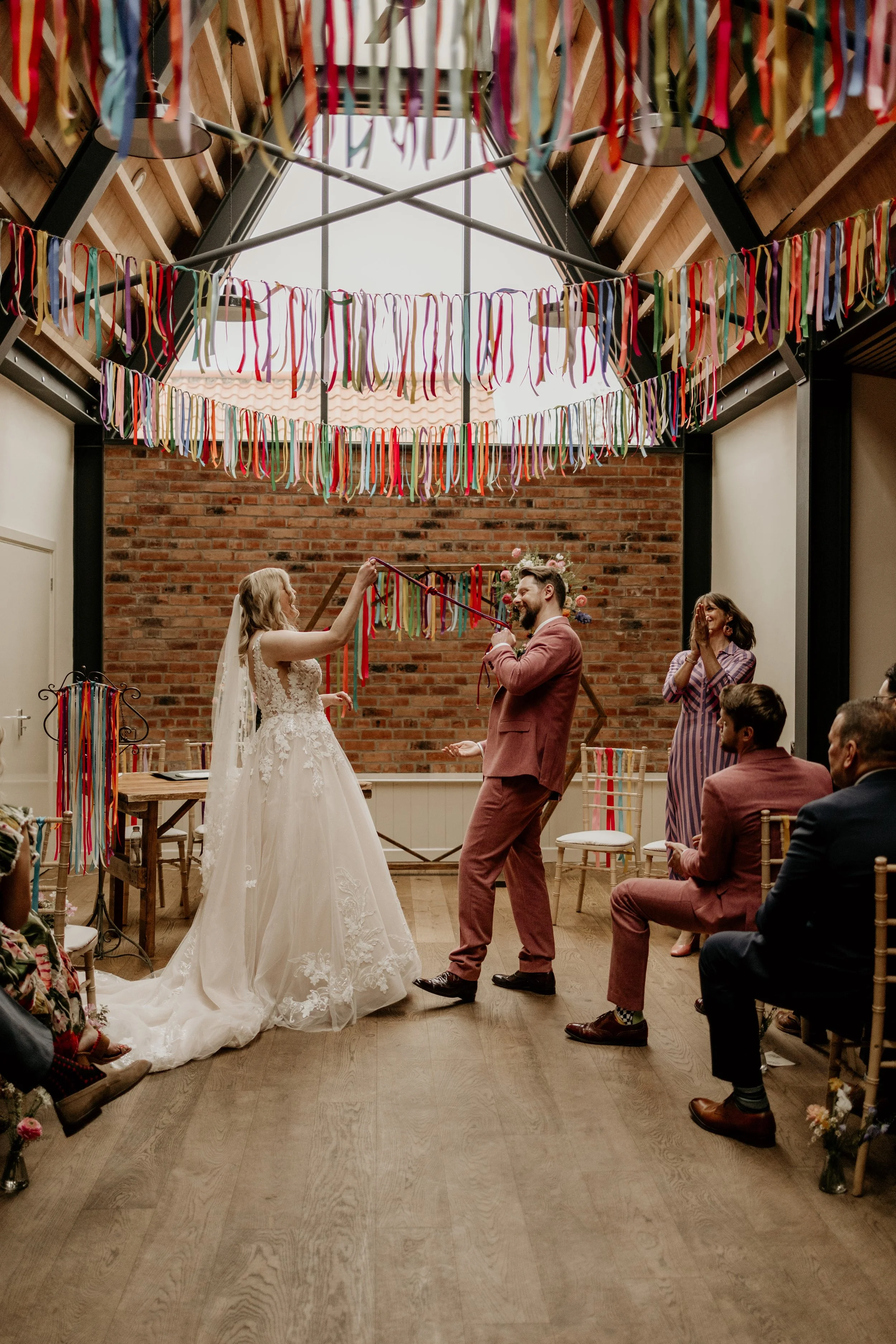 Relaxed wedding photography of a couple during their colourful wedding ceremony