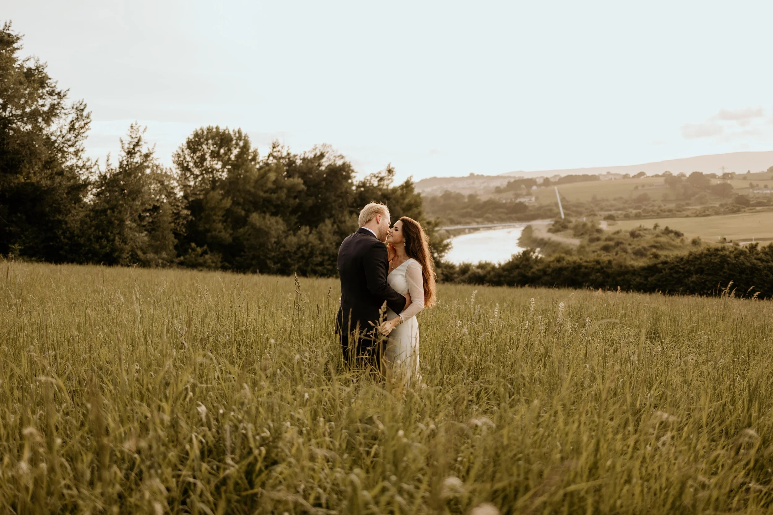 Relaxed wedding photography of a couple standing in the field