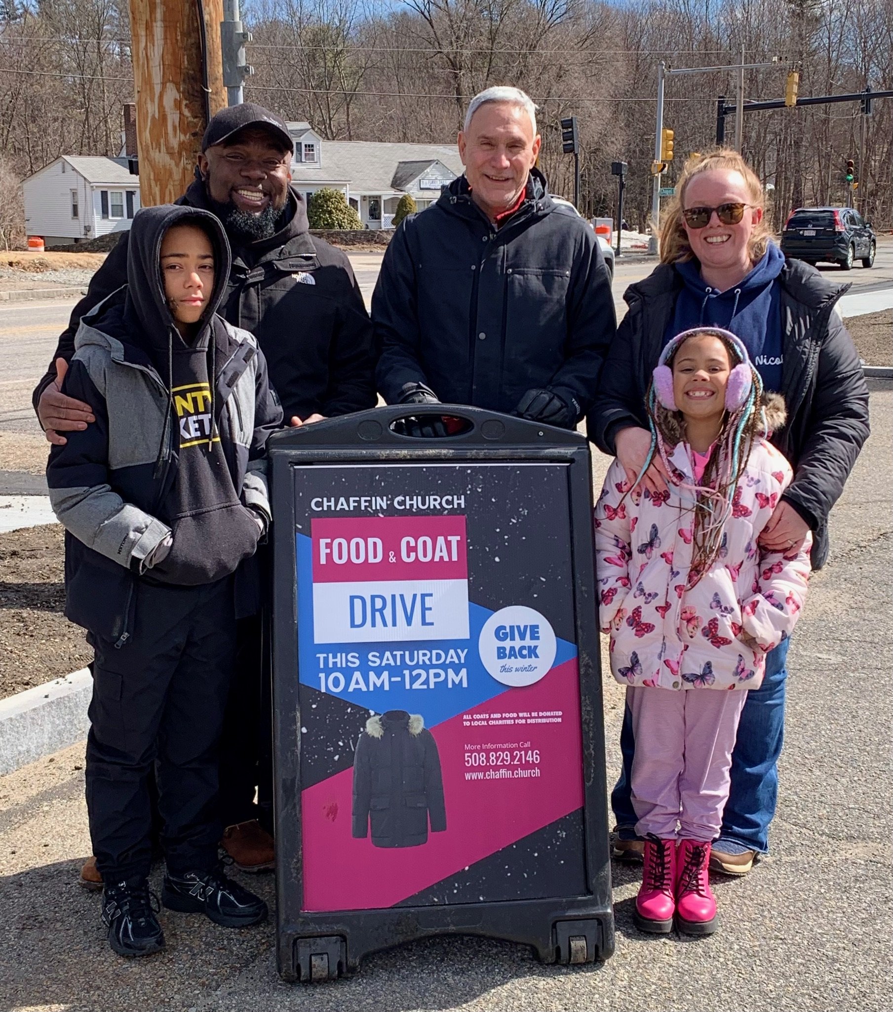 Chaffin Church volunteers at the Food and Coat Drive sign in Holden