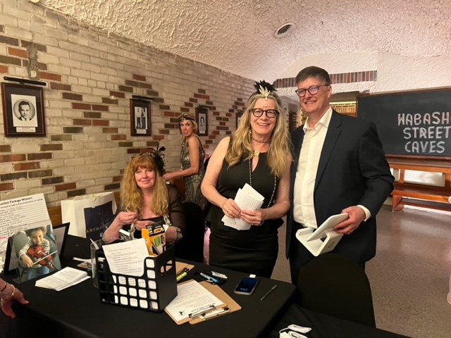 Lisa Roehl, Ann Farrell, and Ann and Steve Lahm keep track of the auction items.  Jenni Roehl, not pictured, is also tallying the popular flapper favorite auction items. 