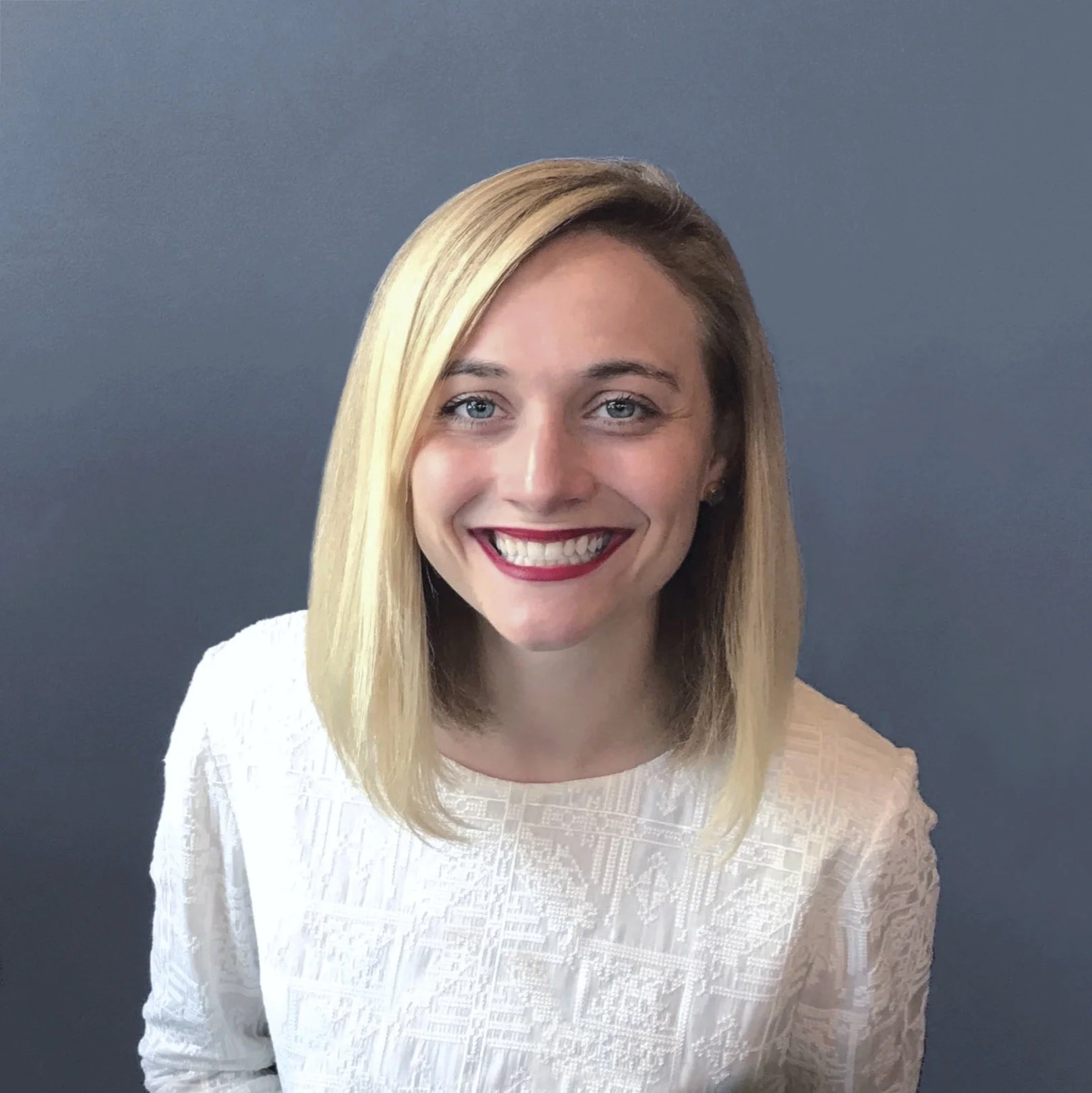 smiling woman with blonde hair and red lipsick